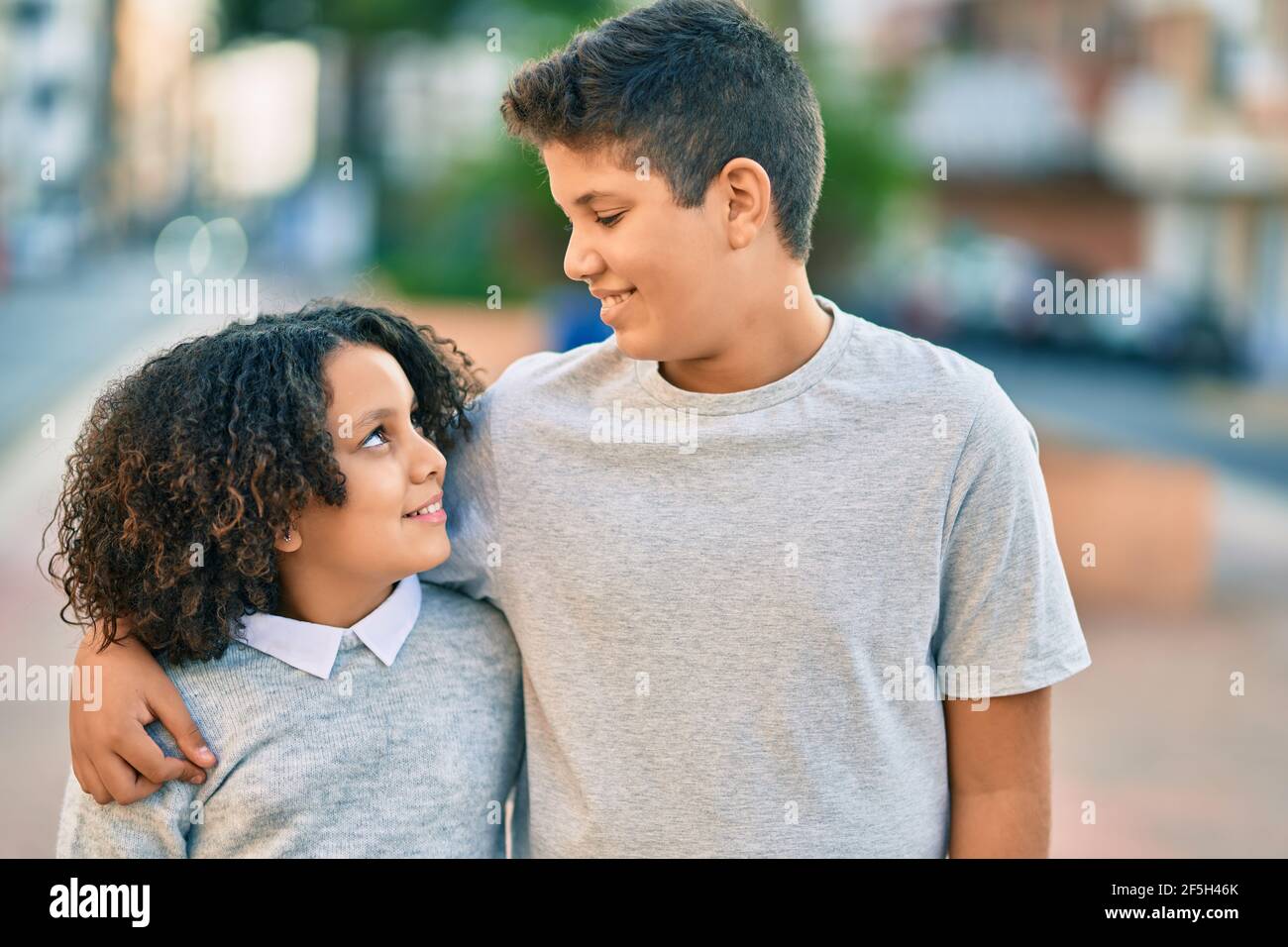 Adorable latin brother and sister hugging at the park Stock Photo - Alamy