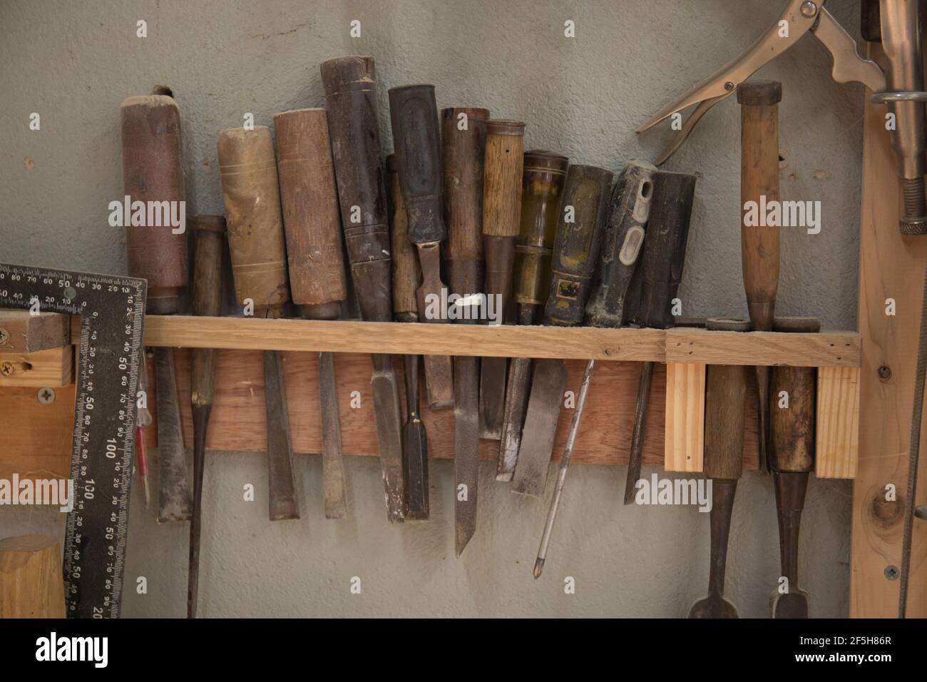Closeup shot of old working tools hanging Stock Photo