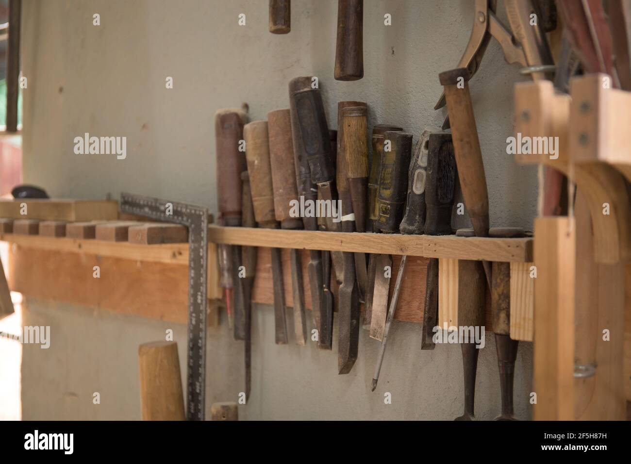 Closeup shot of old working tools hanging Stock Photo