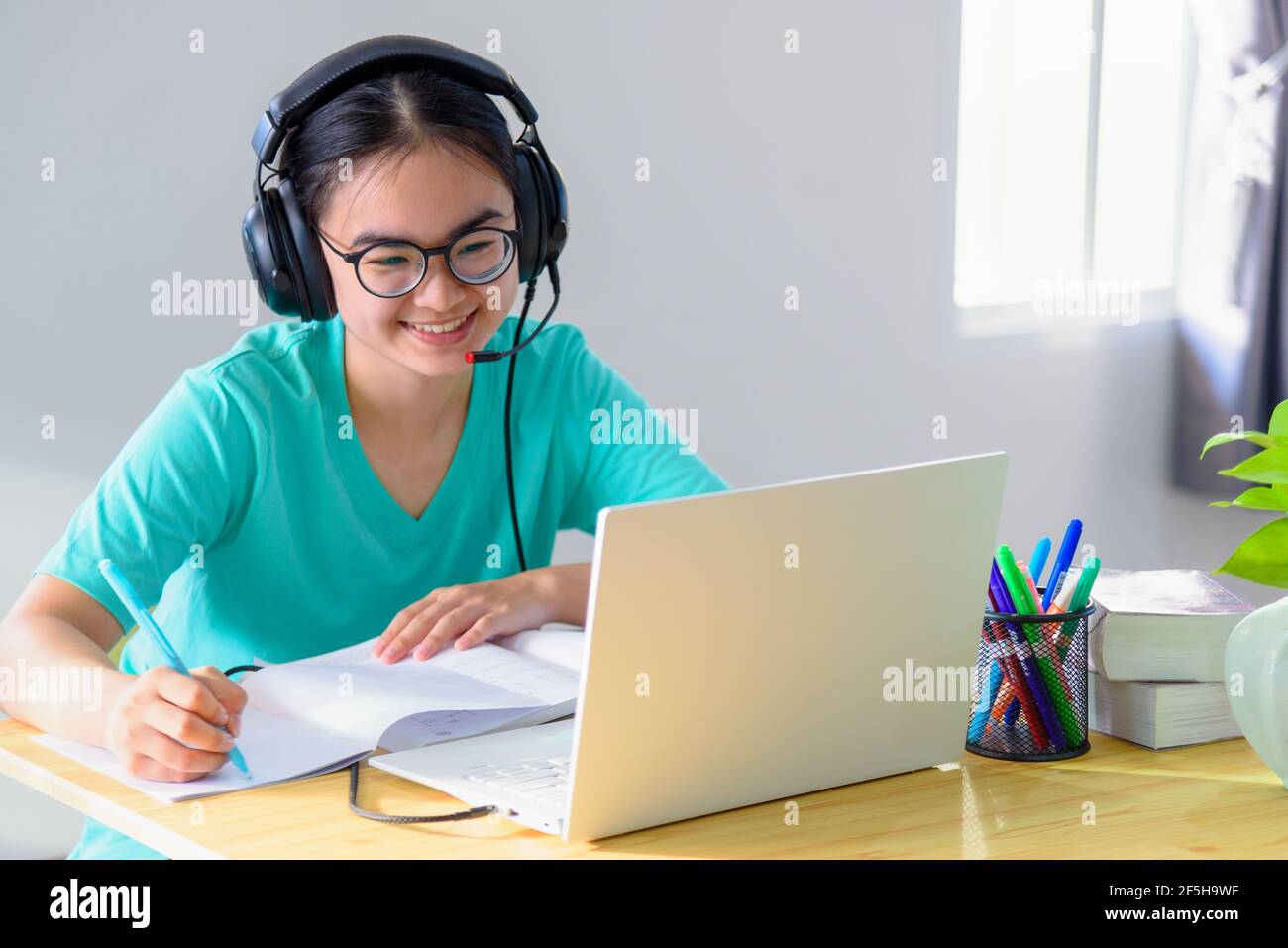 Asian young woman student with glasses headphones girl study happy ...
