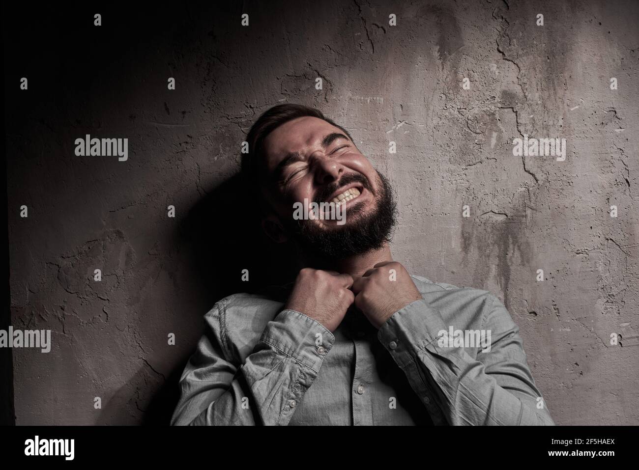 A handsome young man with a beard. The emotions of a man. Depression or hopelessness. Dramatic emotional portrait of a man. High quality photo Stock Photo