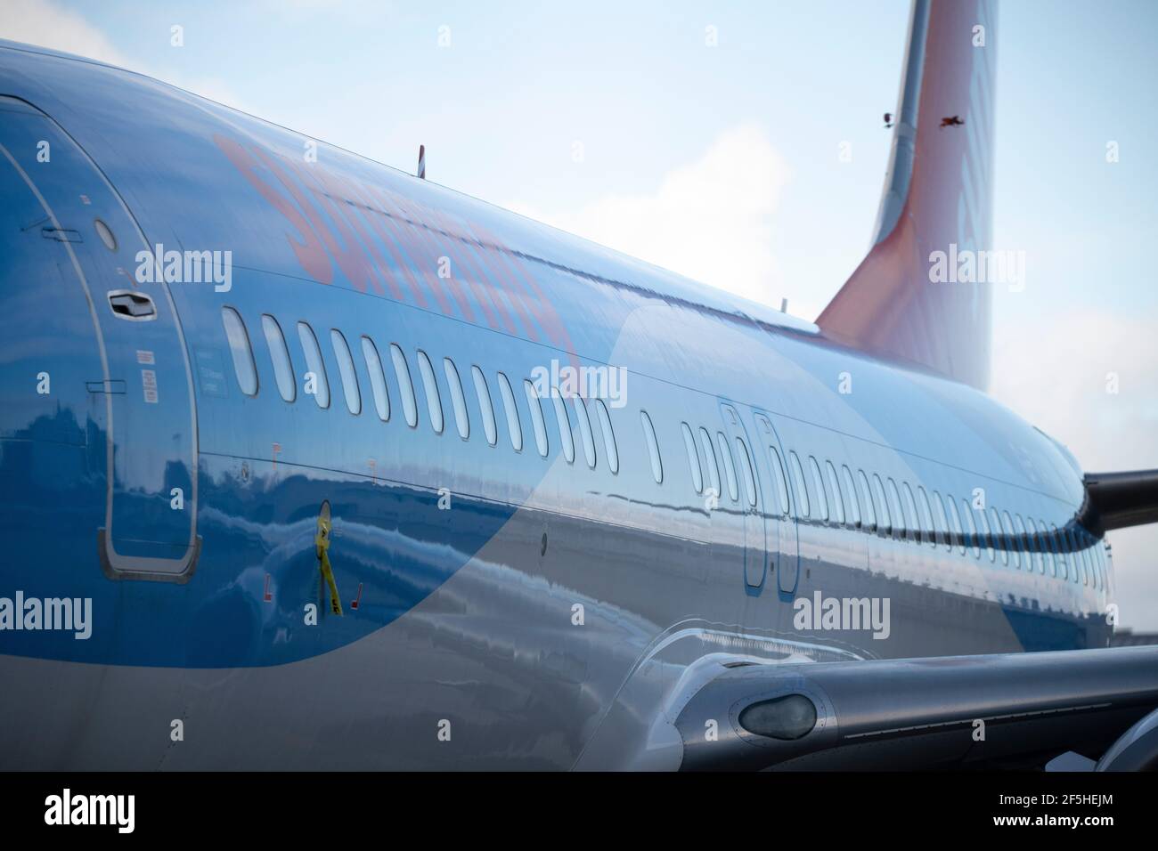 Glasgow, Scotland, UK. 26th Mar, 2021. PICTURED: Sunwing jet plane seen in Tui colours sits on the airport tarmac. Tui has reduced its capacity for this summer from 80% to 75% of 2019's level, with summer bookings appearing to have stalled, whilst operator Tui described bookings as “encouraging” at the group's annual general meeting (AGM) yesterday. The company reported group bookings for summer 2021 remain unchanged at 2.8 million, the same figure it reported in early February, leaving bookings 60% down on the comparable period in 2019. Credit: Colin Fisher/Alamy Live News Stock Photo