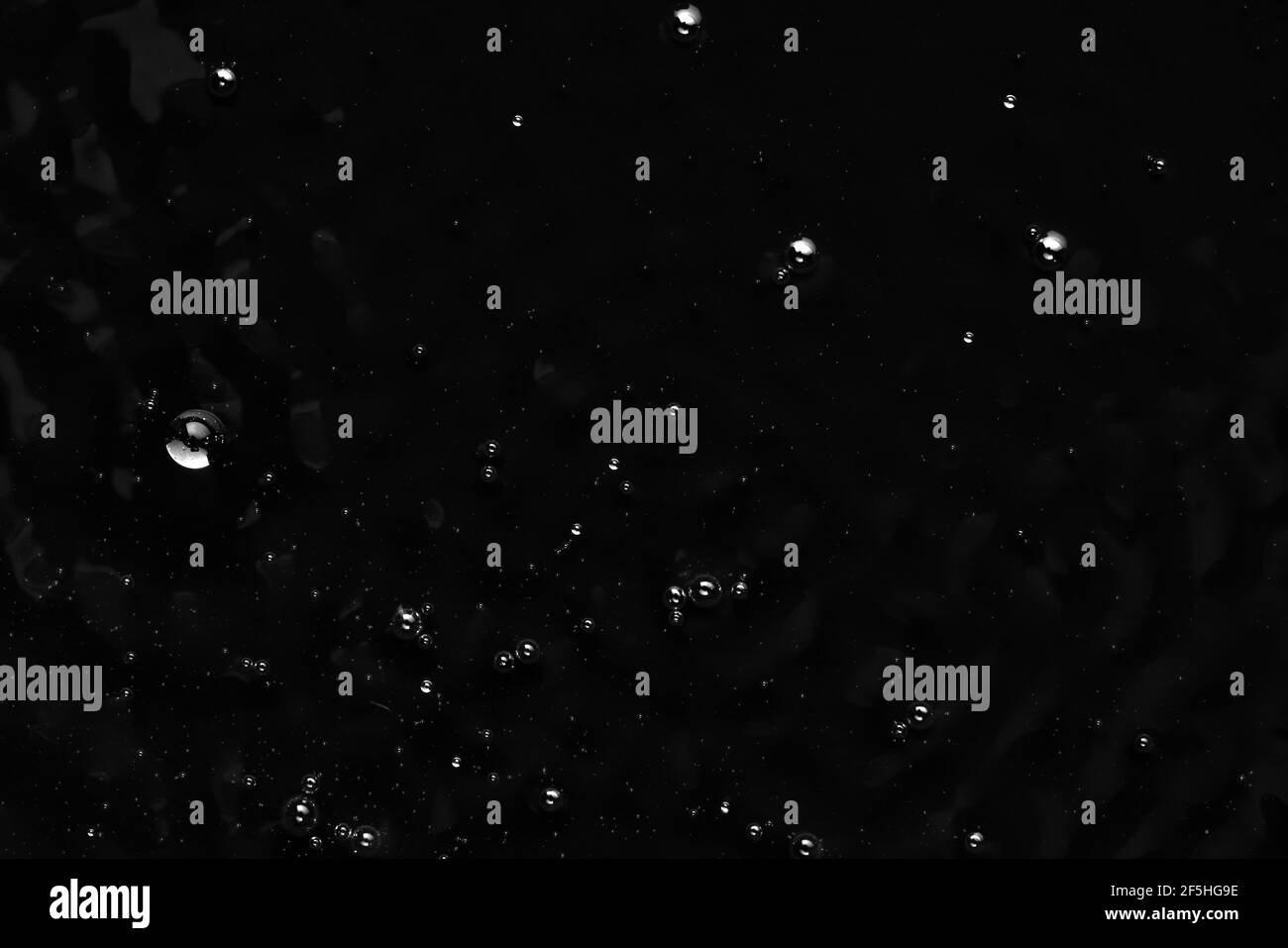 Bubbles on the surface of the liquid. Abstract Black Background Liquid ...