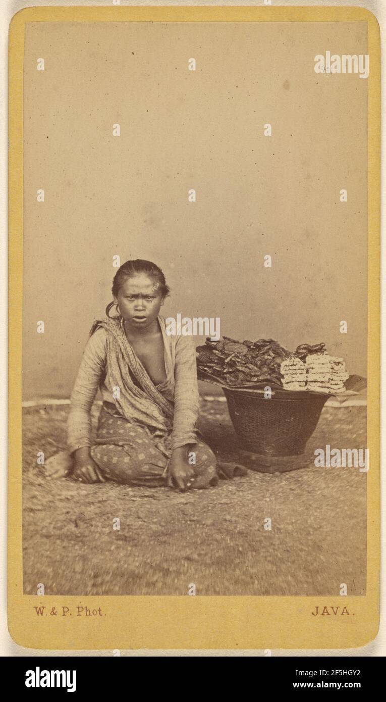 Javanese woman seated with legs crossed, basket at side. Woodbury & Page (British, active 1857 - 1908) Stock Photo