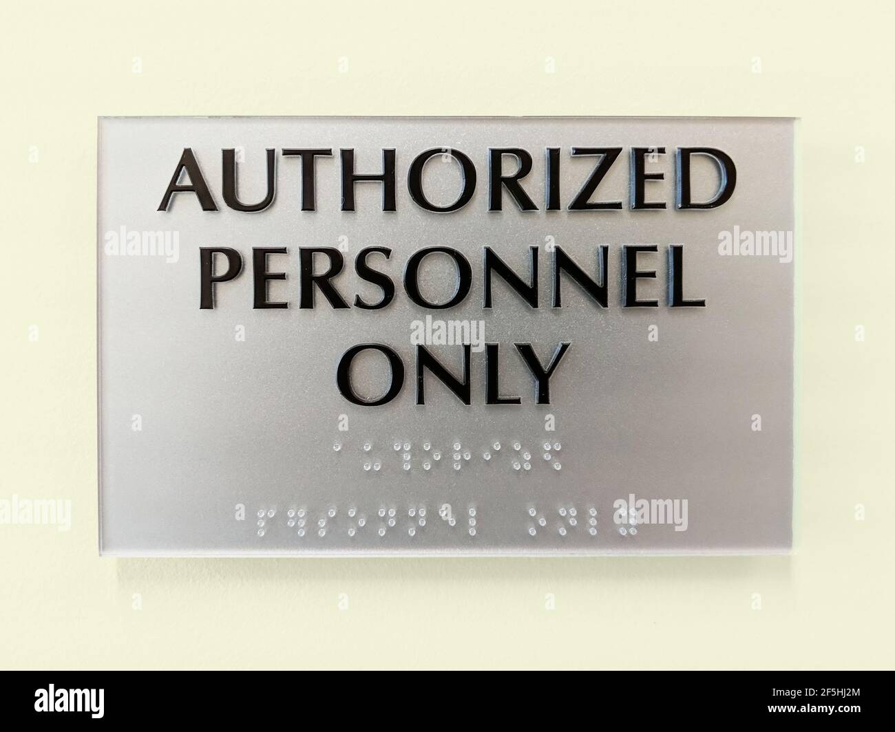 Modern Acrylyic Authorized Personnel Only Sign with Braille Stock Photo