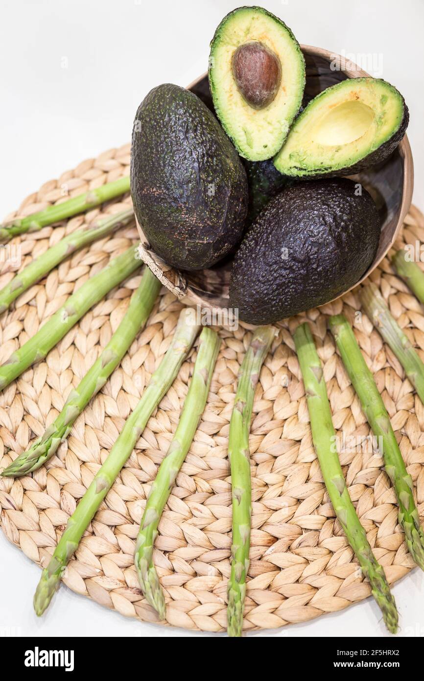 Vertical top view of sliced and whole ripe and avocados arranged on ...