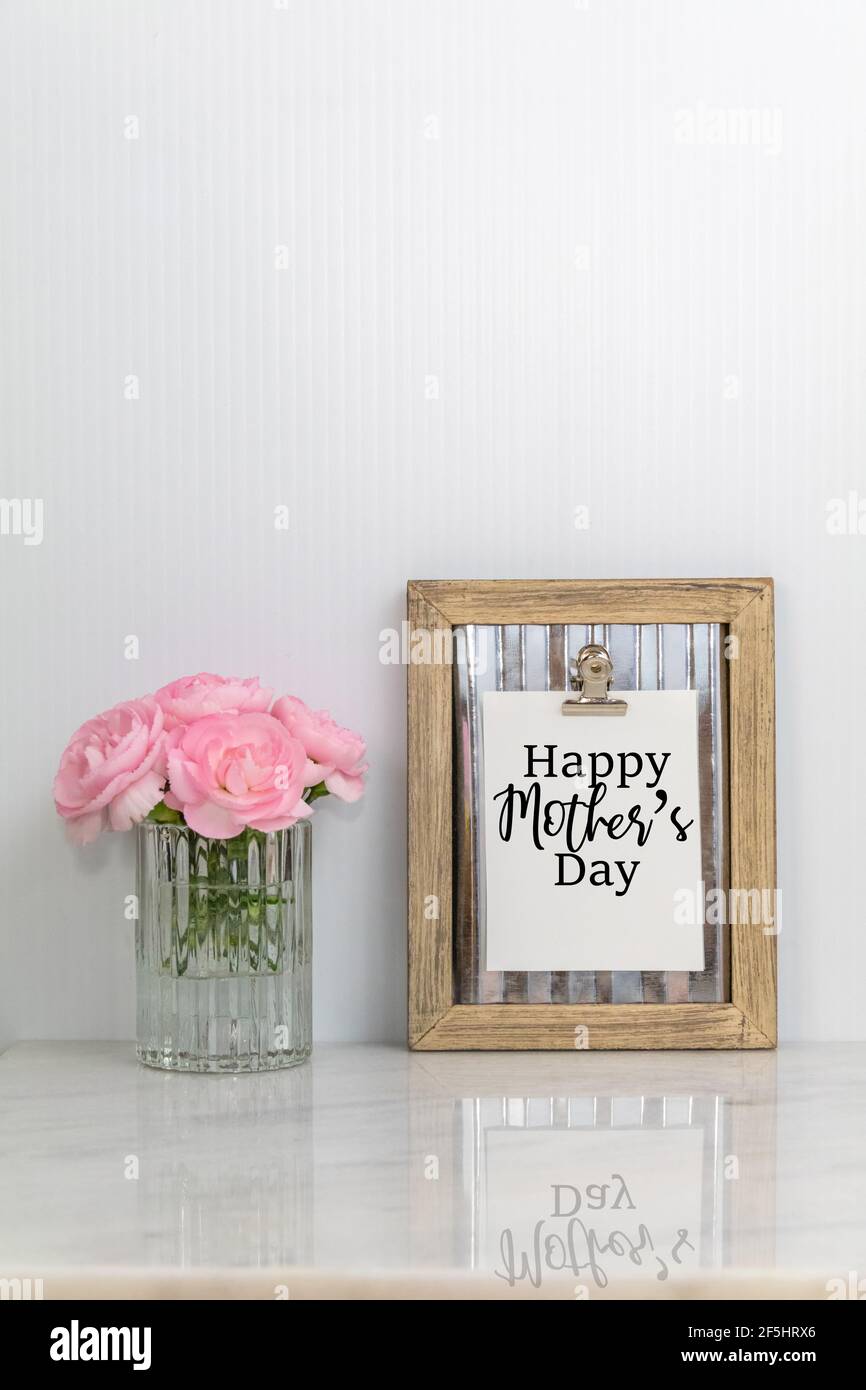 Happy Mother's Day text on rustic clipboard with pink flowers portrait