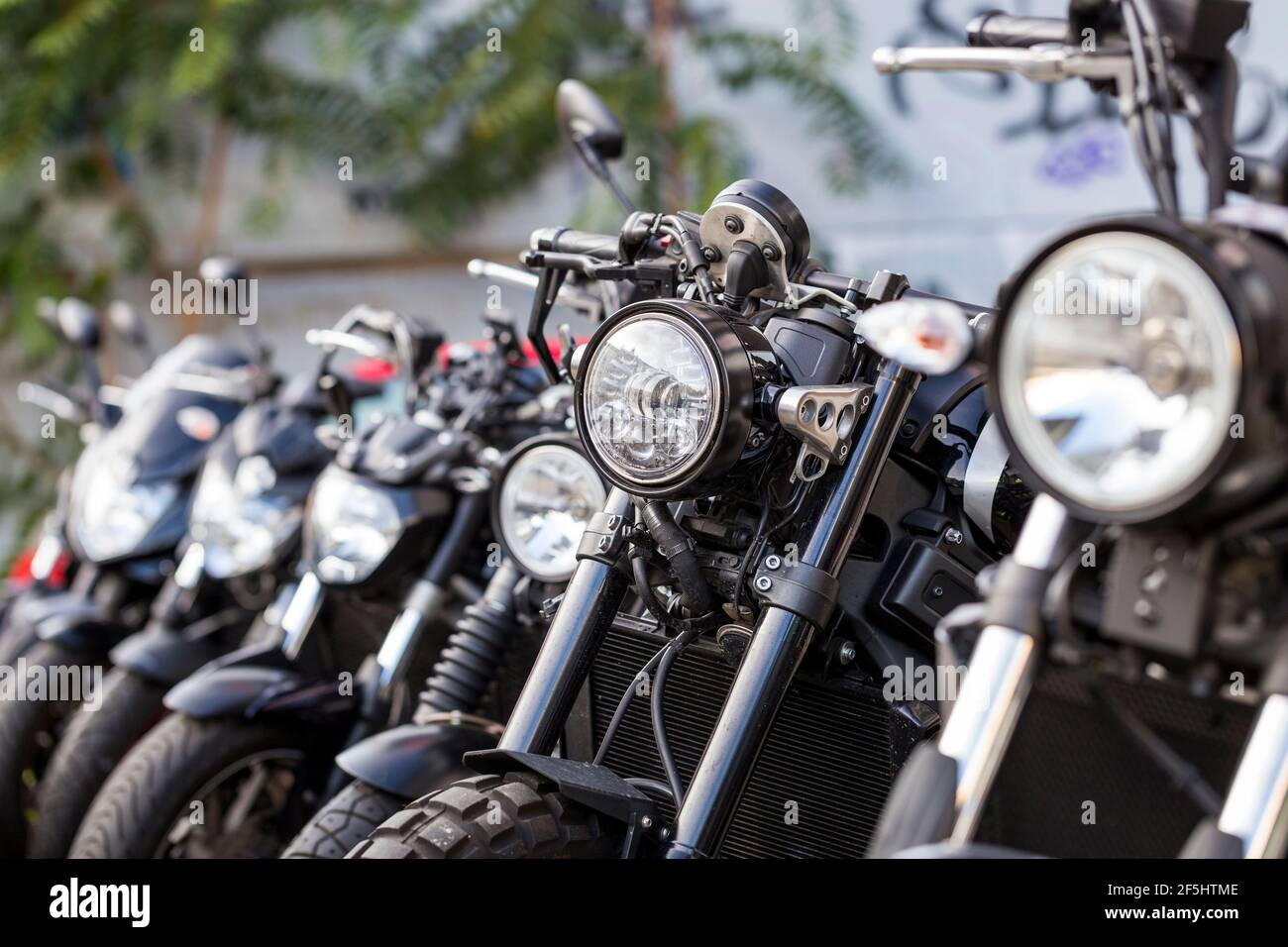 Several motorcycles for sale. Detail of cycles parked next to each other in a motorbike dealership. Stock Photo