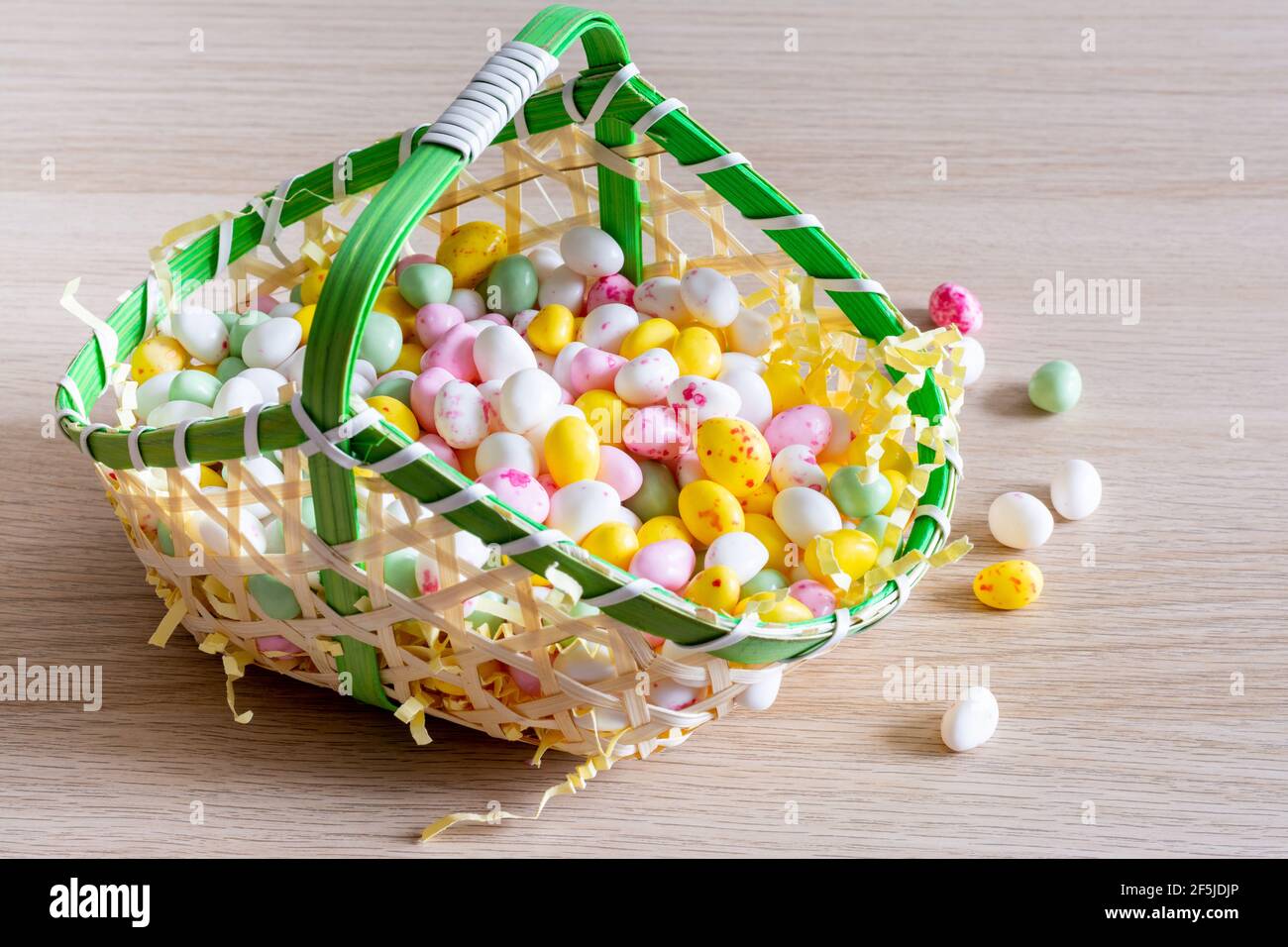 Easter. Basket filled with small sugar eggs Stock Photo