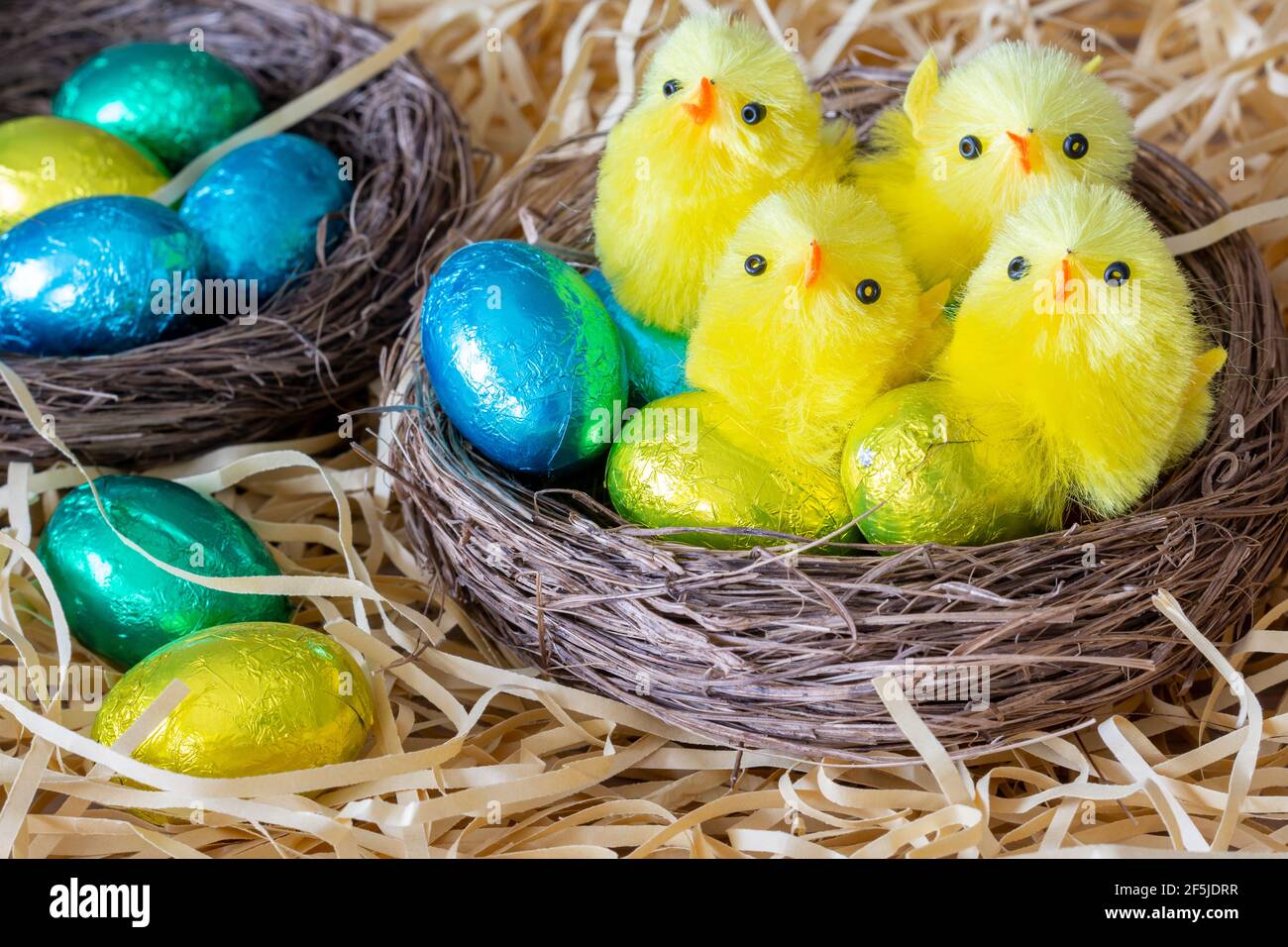 Easter. Small nests decoration with synthetic chicks and easter eggs Stock Photo