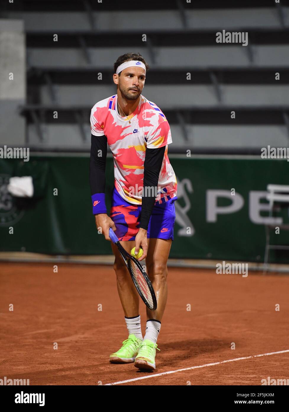 Grigor Dimitrov serving at the French Open (Roland Garros 2020) during his first round against Grégoire Barrère. Stock Photo