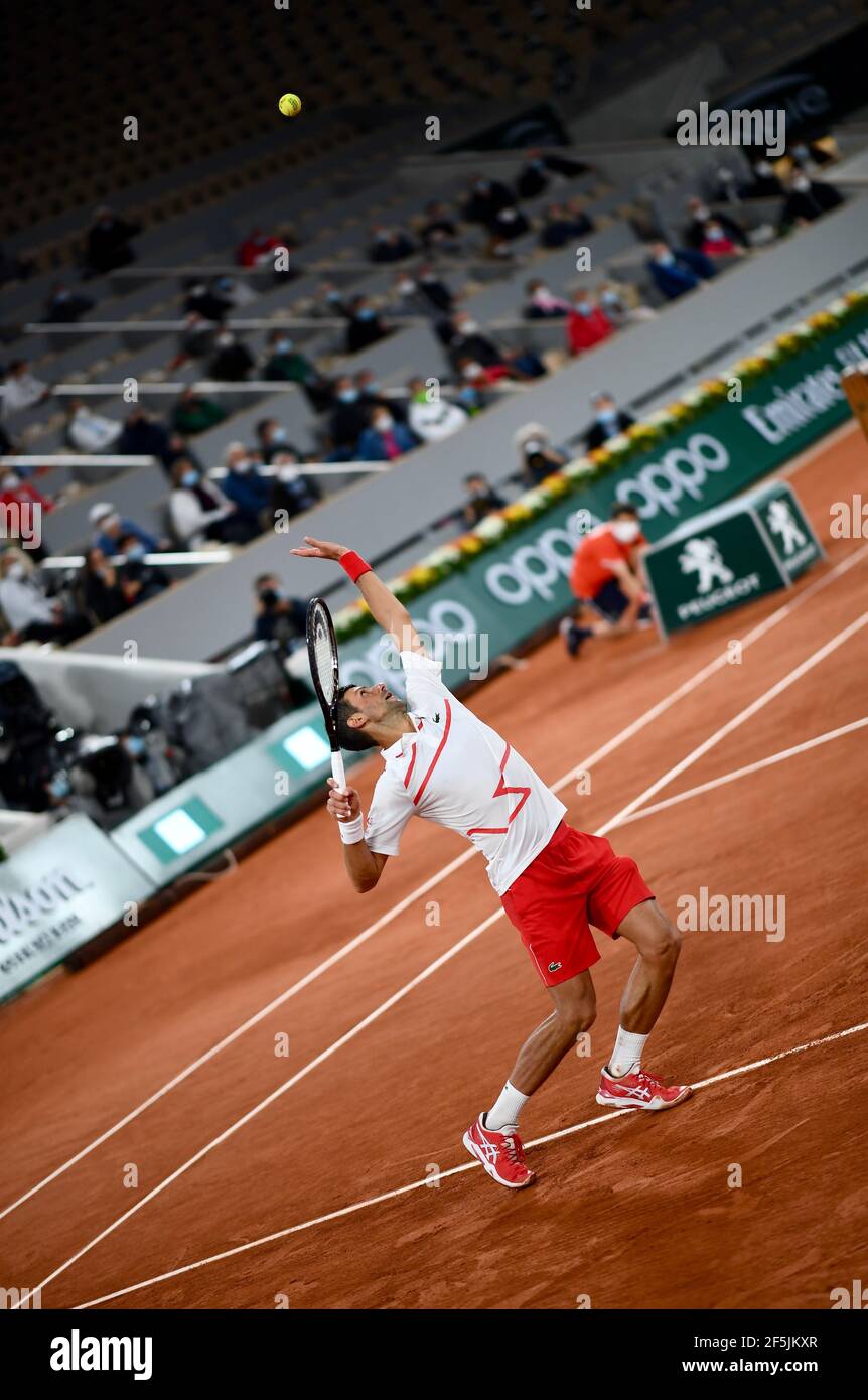 Novak Djokovic serving at the French Open (Roland Garros 2020) during his first round against Mikael Ymer. Stock Photo