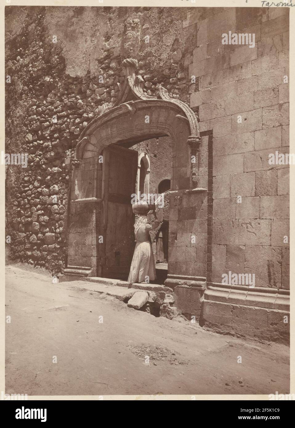 Woman entering gate. Baron Wilhelm von Gloeden (German, 1856 - 1931) Stock Photo