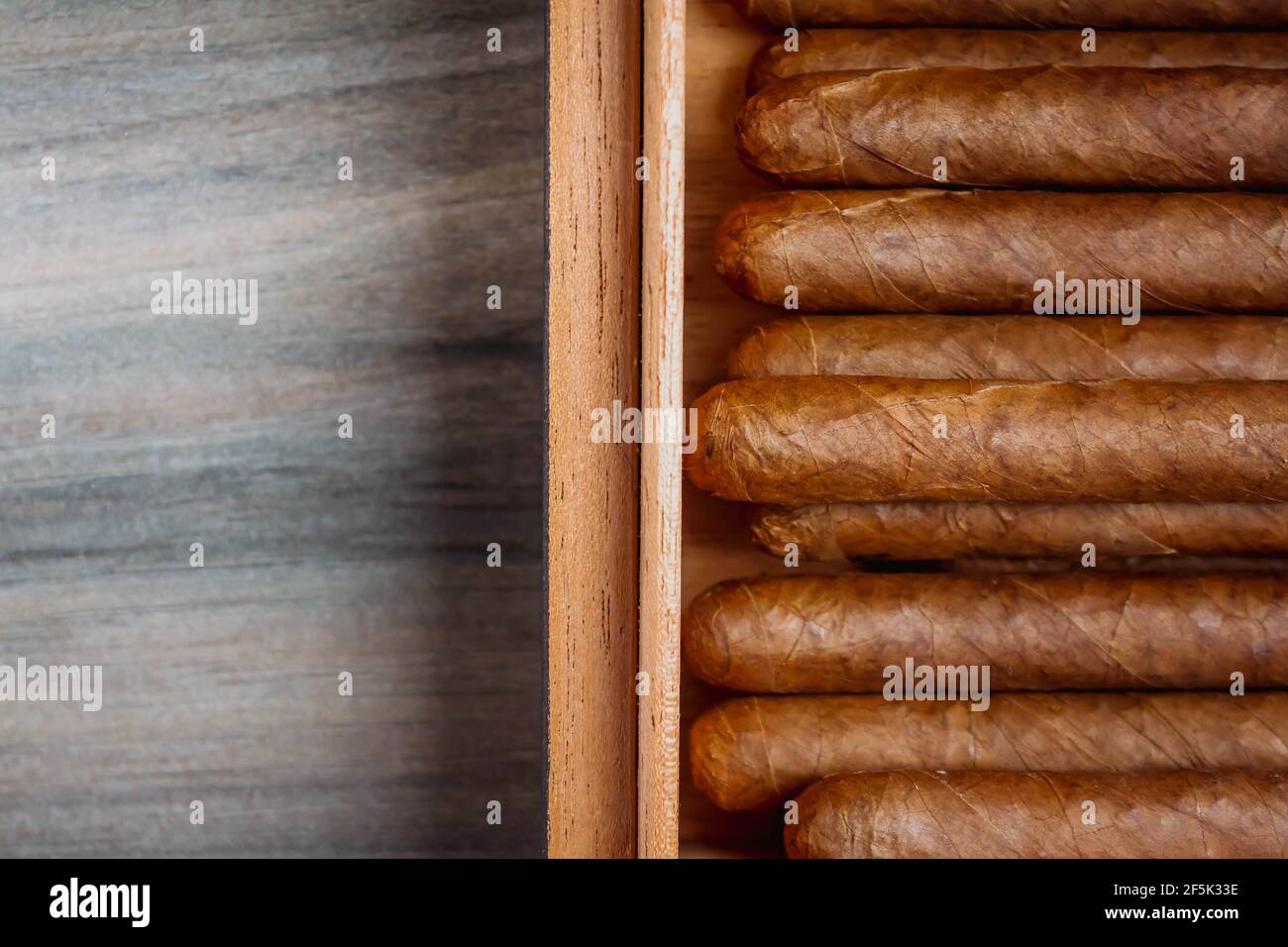Cigars in humidor on the wooden background Stock Photo