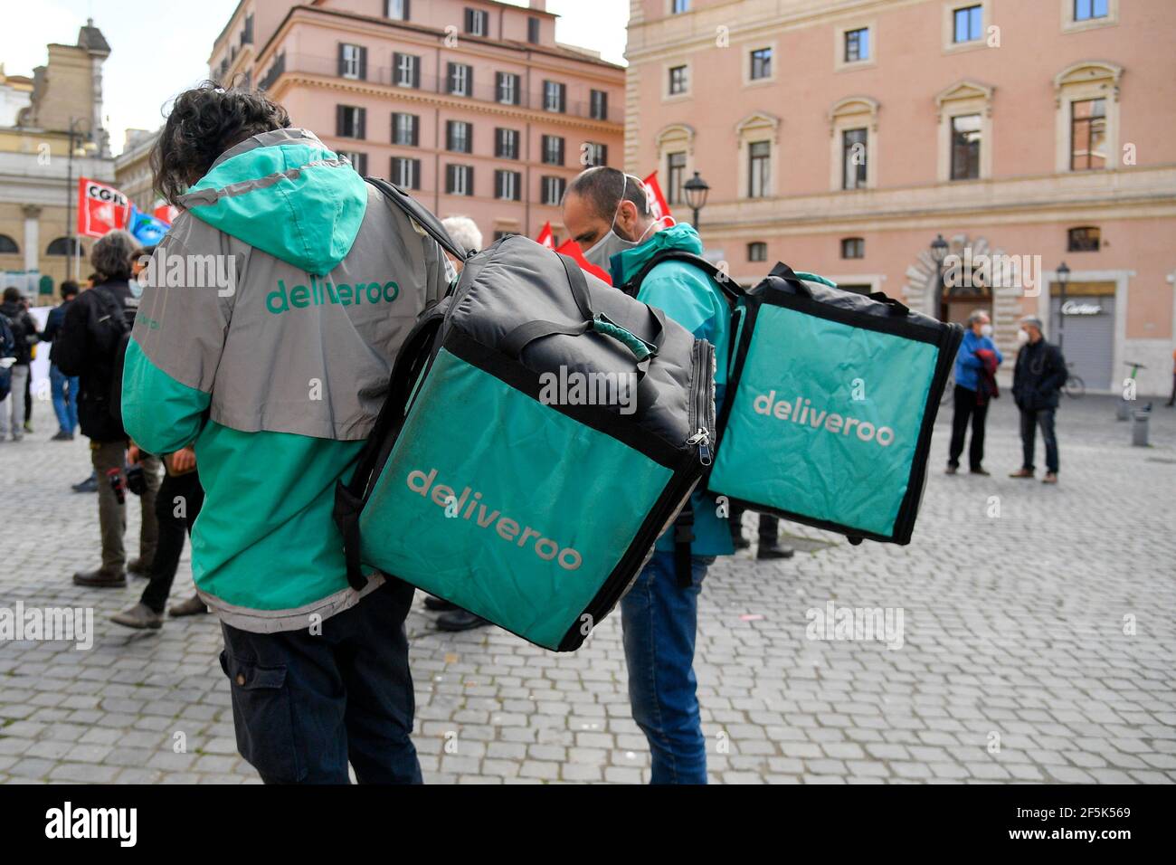 Roma, Italy. 26th Mar, 2021. Delivery men from Deliveroo seen during the demonstration.Delivery riders protest in a ‘No delivery day Rider demonstration' at Piazza San Silvestro Rome asking for real contracts with better protection, concrete guarantees, fairness and respect for their work with adequate remuneration. (Photo by Fabrizio Corradetti/SOPA Image/Sipa USA) Credit: Sipa USA/Alamy Live News Stock Photo