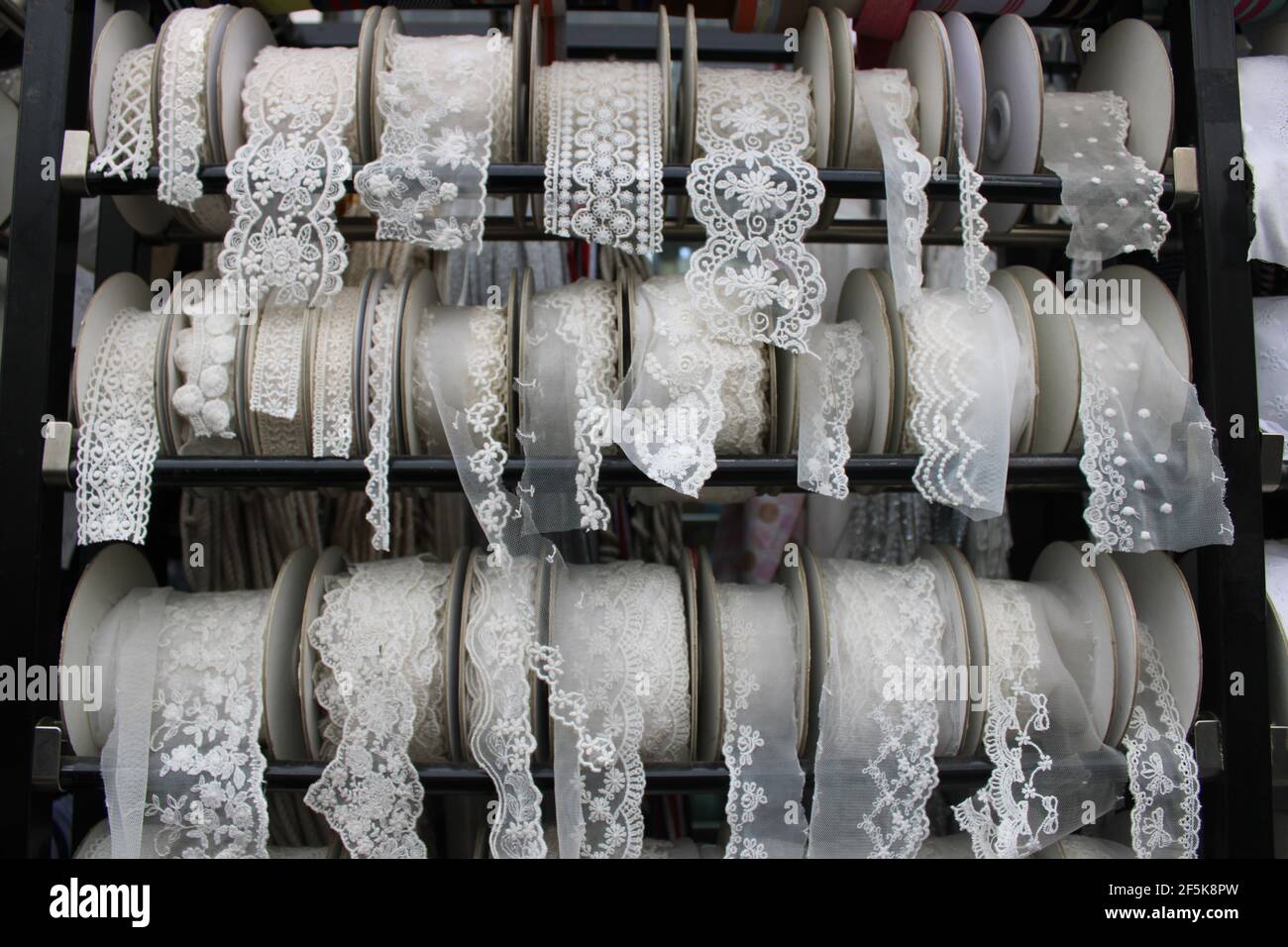 Spools of white and cream lace ribbon, in a textile market Stock Photo -  Alamy