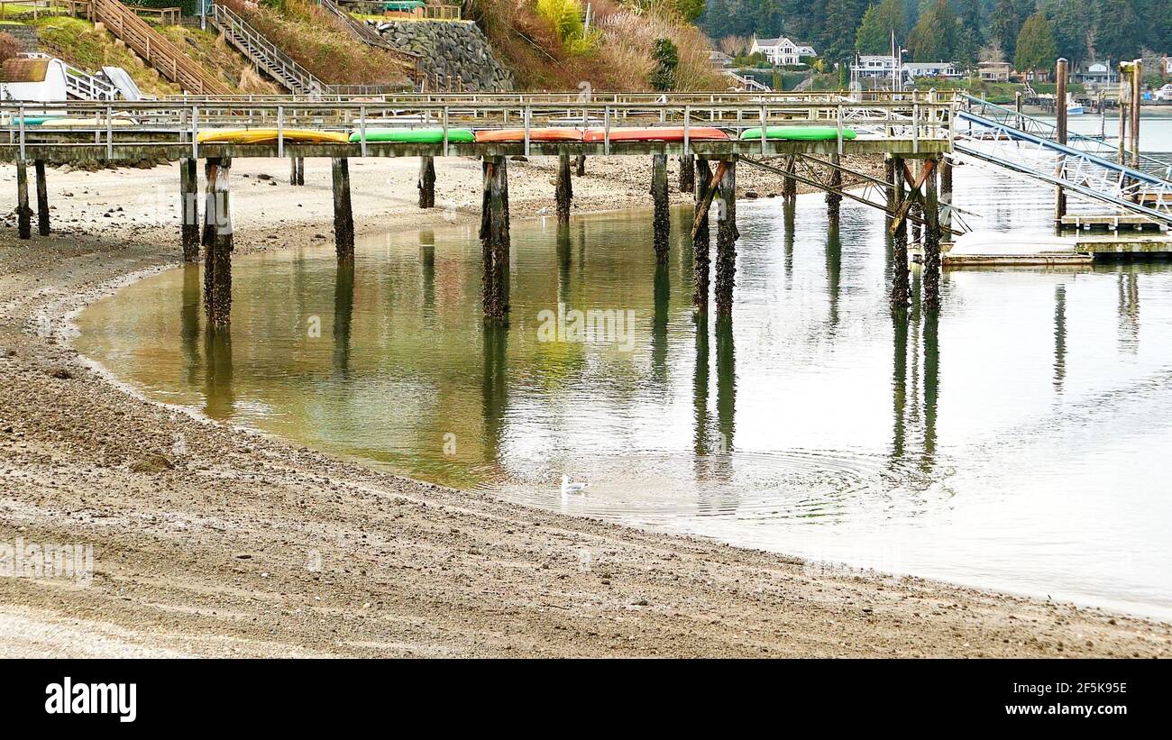 wooden pier and kayaks on the lake Stock Photo - Alamy