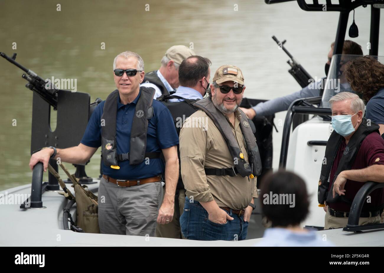 Granjeno, Texas, USA, 26th Mar, 2021. Left to right, Sen. THOM TILLIS of North Carolina, Sen. TED CRUZ of Texas, and Sen. LINDSEY GRAHAM, of South Carolina, join a delegation of 18 Republican U.S. Senators on a tour of the Rio Grande River south of Mission in four Texas Dept. of Public Safety gunboats. The ride marked the end of a whirlwind tour of south Texas during which the senators saw an overcrowded migrant processing center in Donna and a corpse floating in the river north of Anzalduas Park. Credit: Bob Daemmrich/Alamy Live News Stock Photo