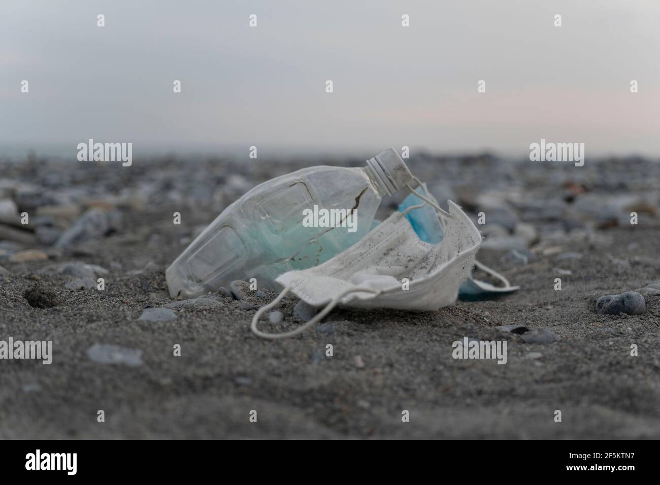Pollution on the beach, plastic including bottles, surgical masks and other garbage Stock Photo