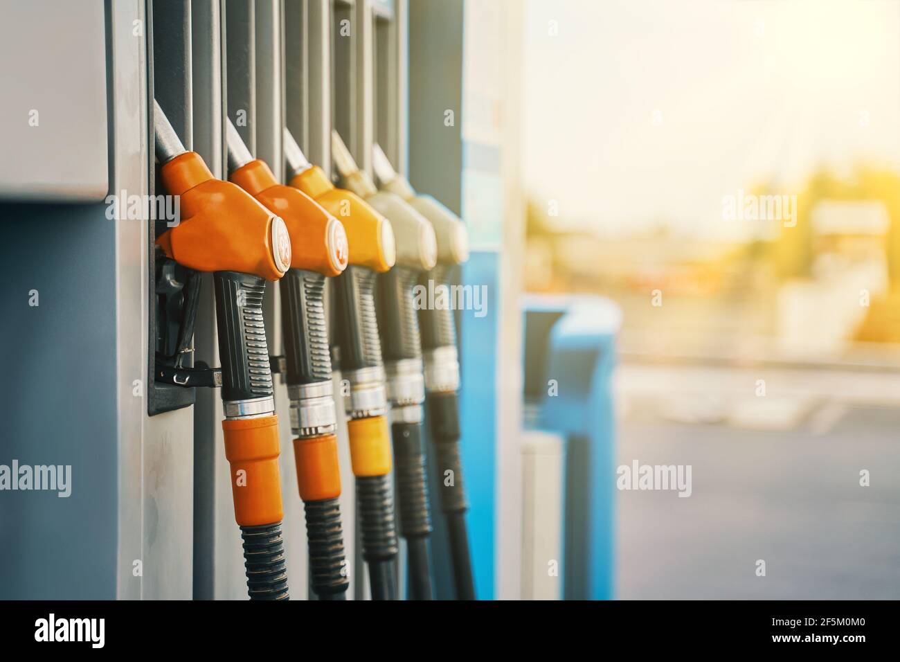 Gas station. Colorful petrol pump filling nozzles. Petrol station in a service in warm sunset. Stock Photo