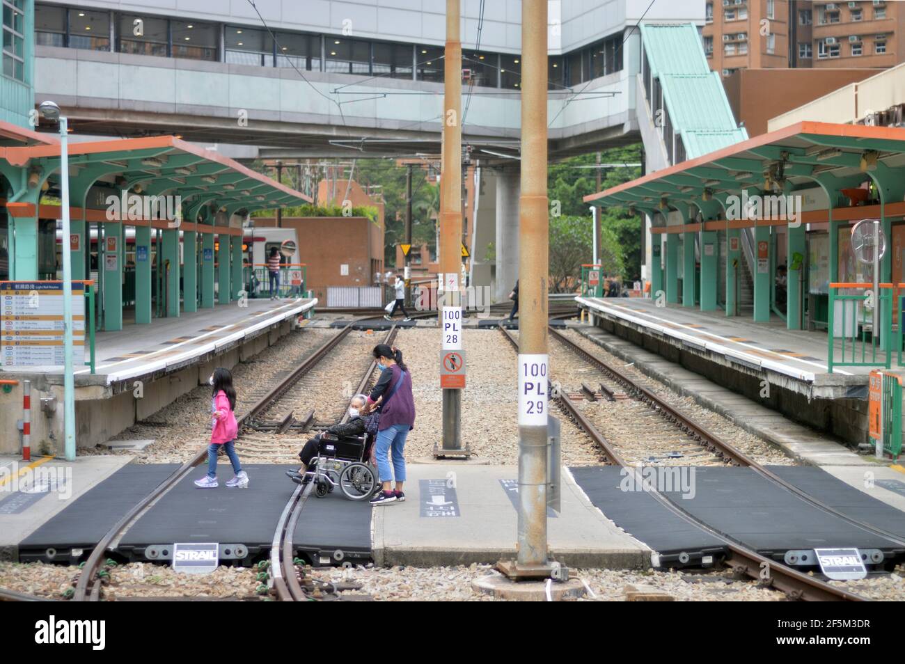 Light rail platforms and at-grade pedestrian crossing at Siu Hong Station (兆康站) in Tuen Mun, Hong Kong Stock Photo