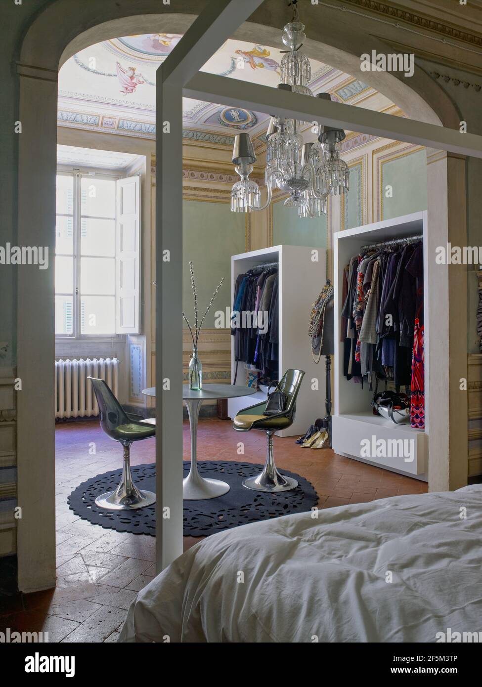 Beautiful bedroom with a wardrobe and canopy bed in a elegant house in Florence, Italy Stock Photo