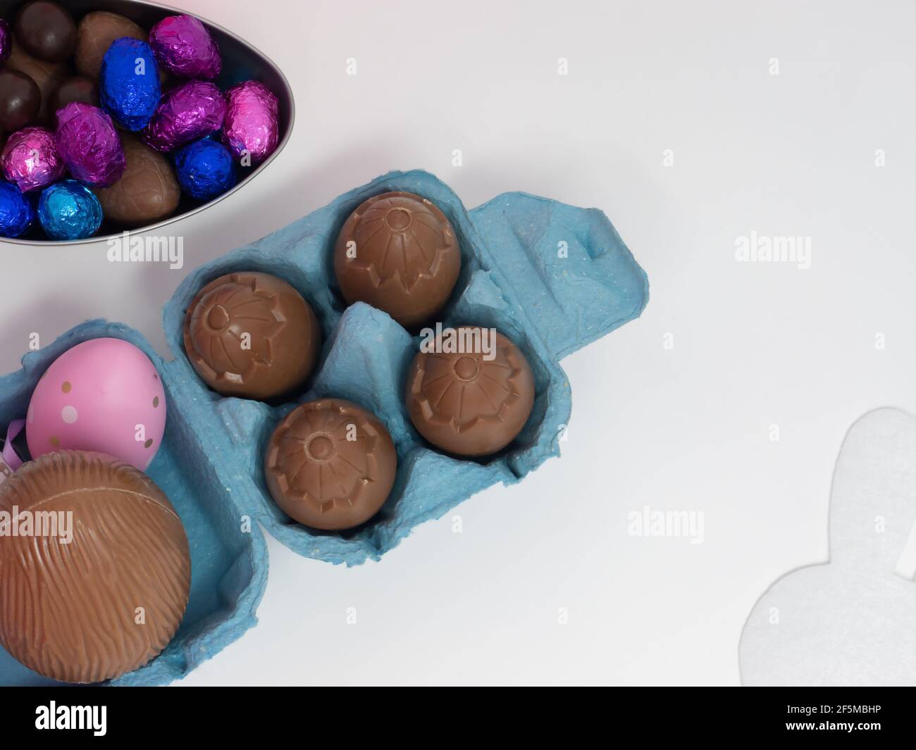 Chocolate Easter eggs in an egg carton and in an eggshaped container