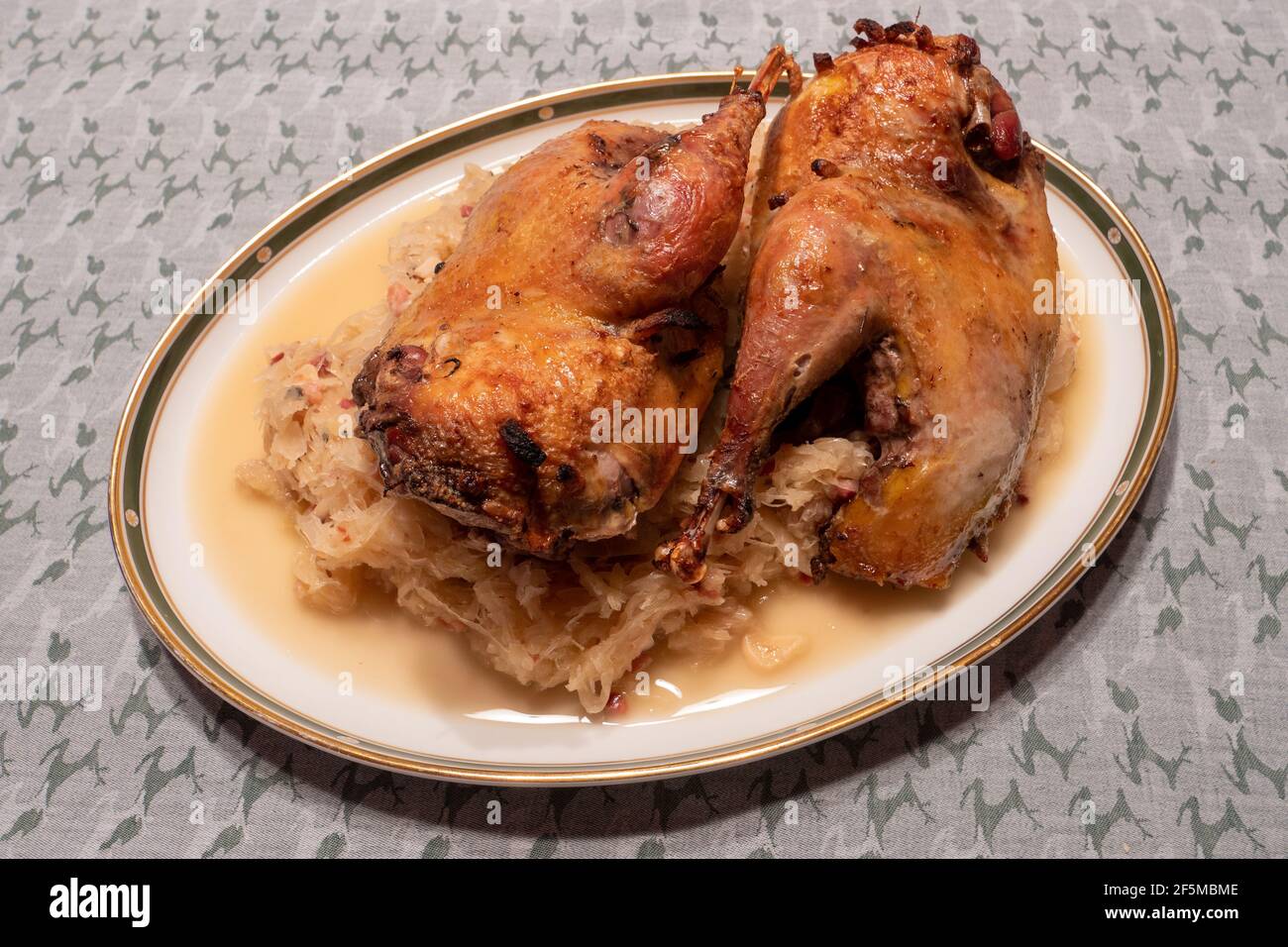 Roast or Braised Pheasant on Sauerkraut, on a Plate, in Traditional Alsatian Style Stock Photo