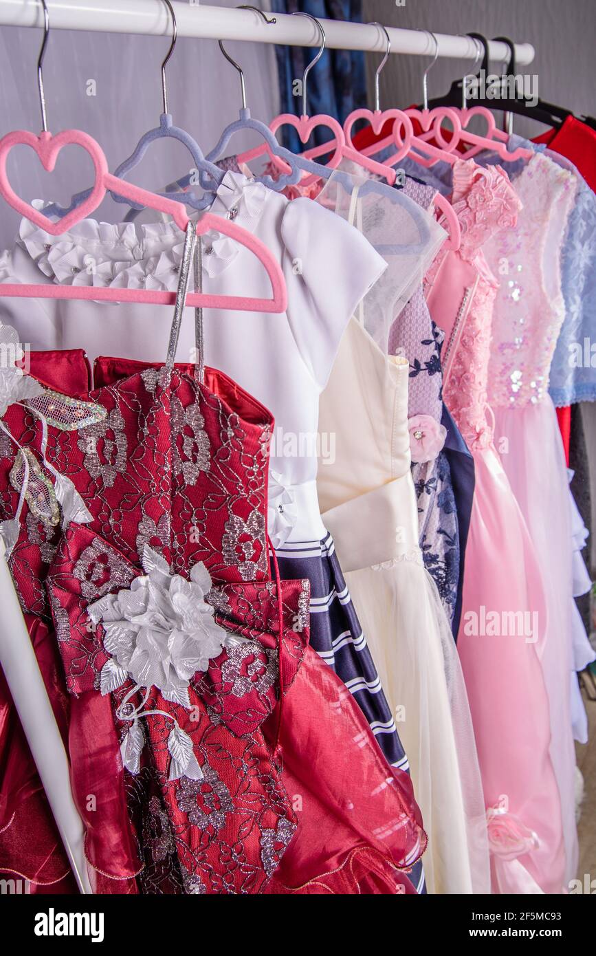 Clothes hangers with colorful clothes in a women shop. Summer sa Stock  Photo by ©Volurol 115457946