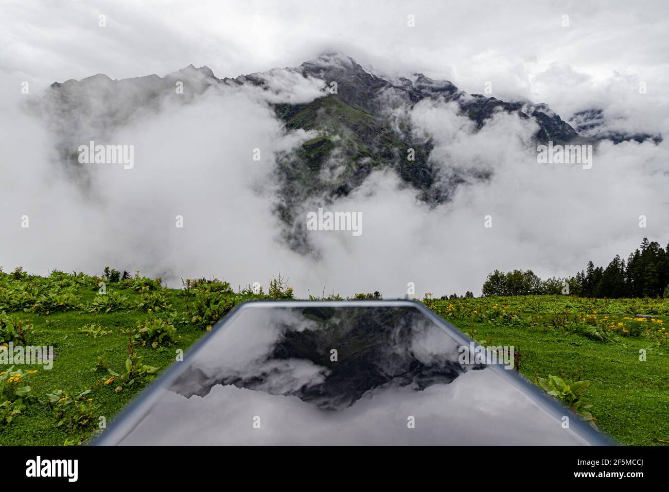 mesmerizing view of clouds in himachal pradesh,with reflection on phone. Stock Photo
