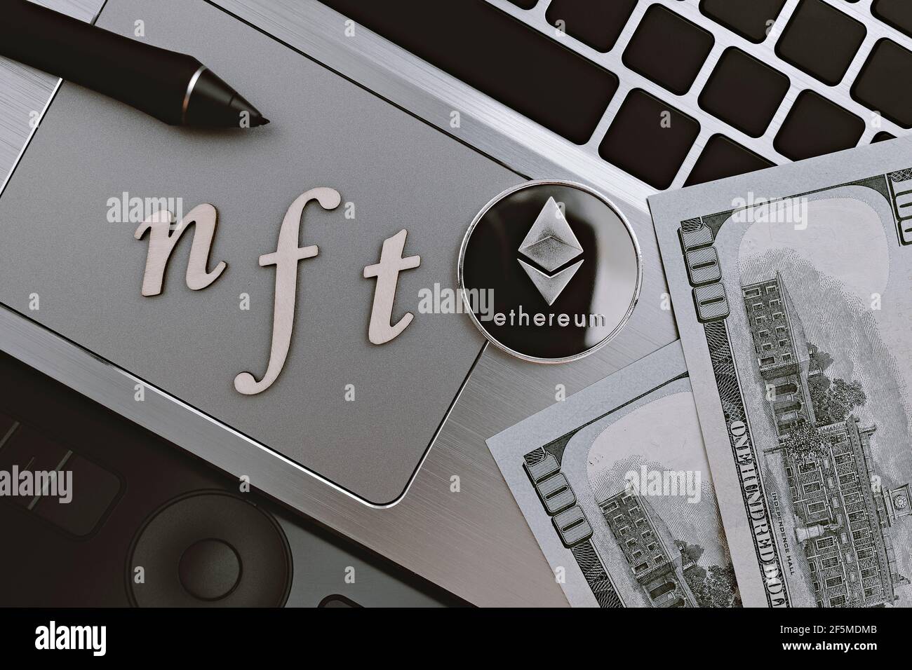 Topview Photo On Nft Non Fungible Token Theme Abbreviation Nft And Ethereum Blockchain Cryptocurrency Coin On The Background Of Laptop And Dollar Stock Photo Alamy