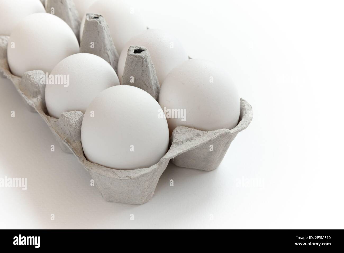 White chicken eggs in box. Cardboard egg box with chicken eggs on white ...