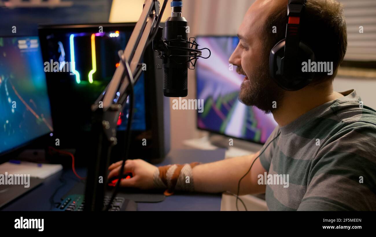 Pro gamer puts professional headphone and start playing space shooter video  game new graphics on powerful computer. Player using two monitors during  online tournament at streaming hone studio Stock Photo - Alamy