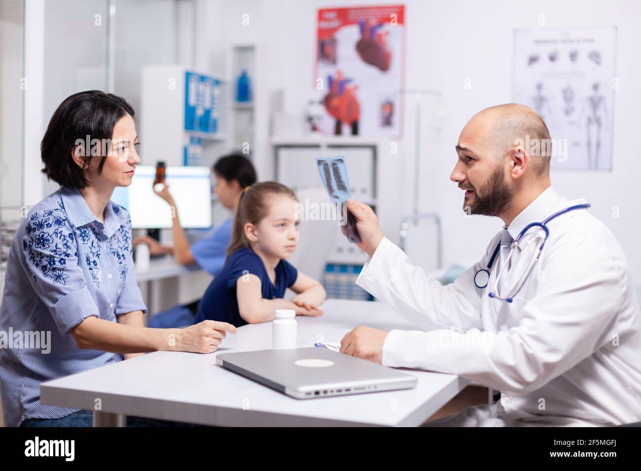 Medical radiologist explaining radiography in hospital office during