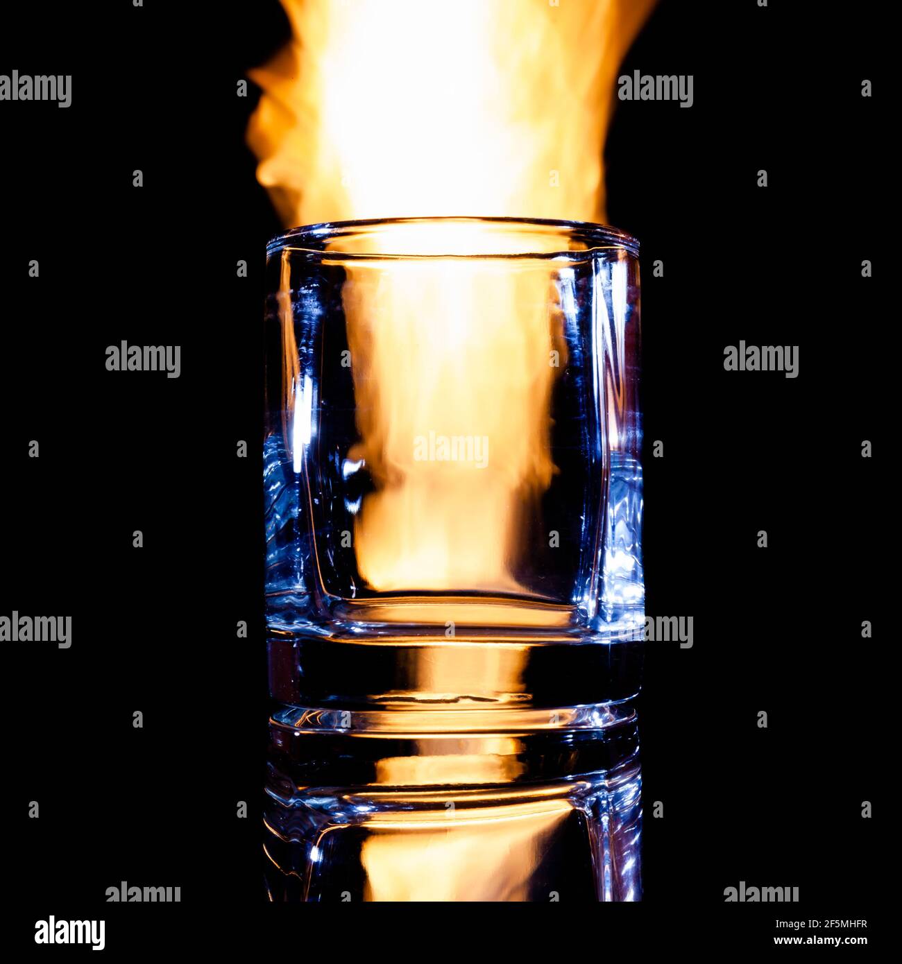 empty glass of brandy on fire, isolate Stock Photo