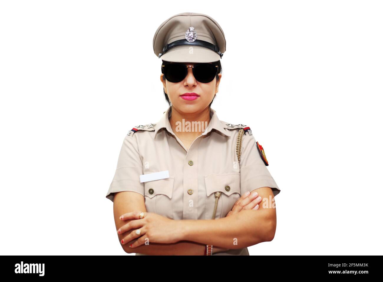 Indian policewoman standing against white background. Stock Photo