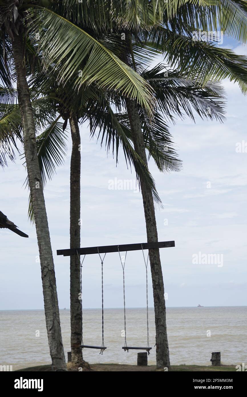 swings on the beach at Miri Marina, Sarawak Stock Photo