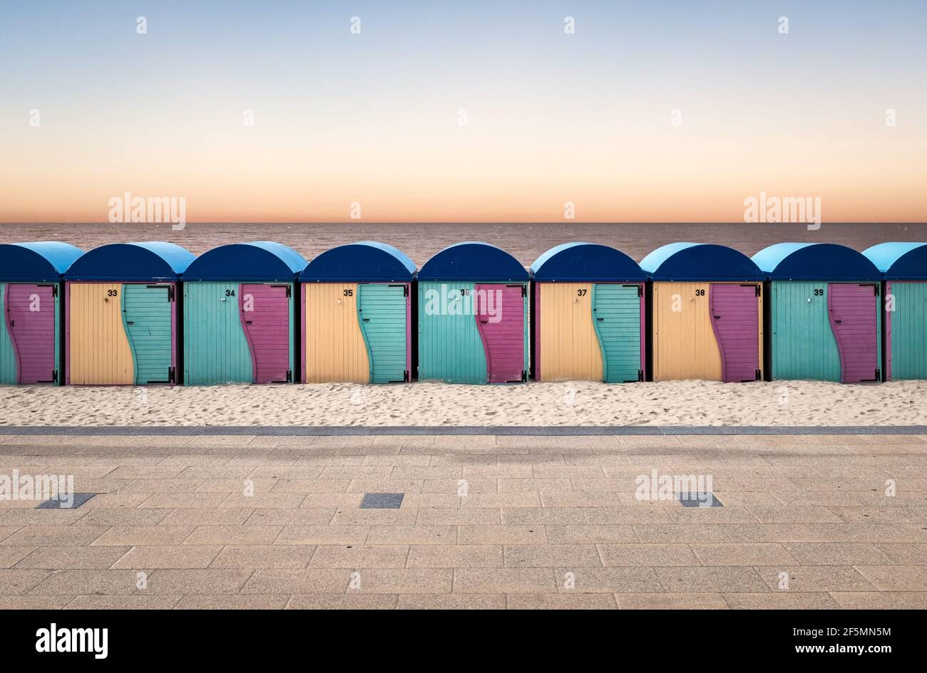Row of vintage wooden beach huts in Dunkirk at sunset Stock Photo