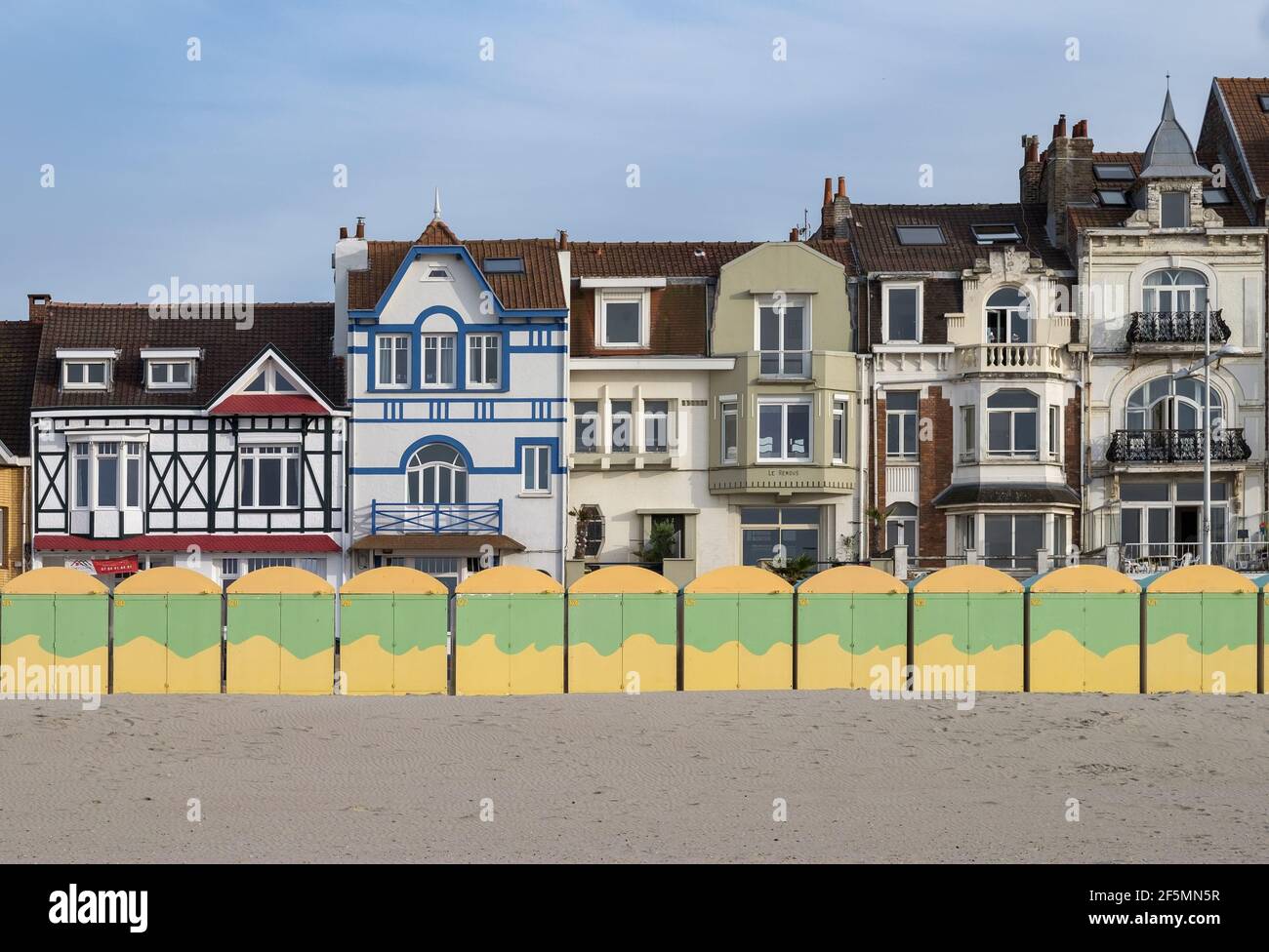 Dunkirk, France - 26 July 2020: Colorful beach huts in front of historic seaside buildings Stock Photo