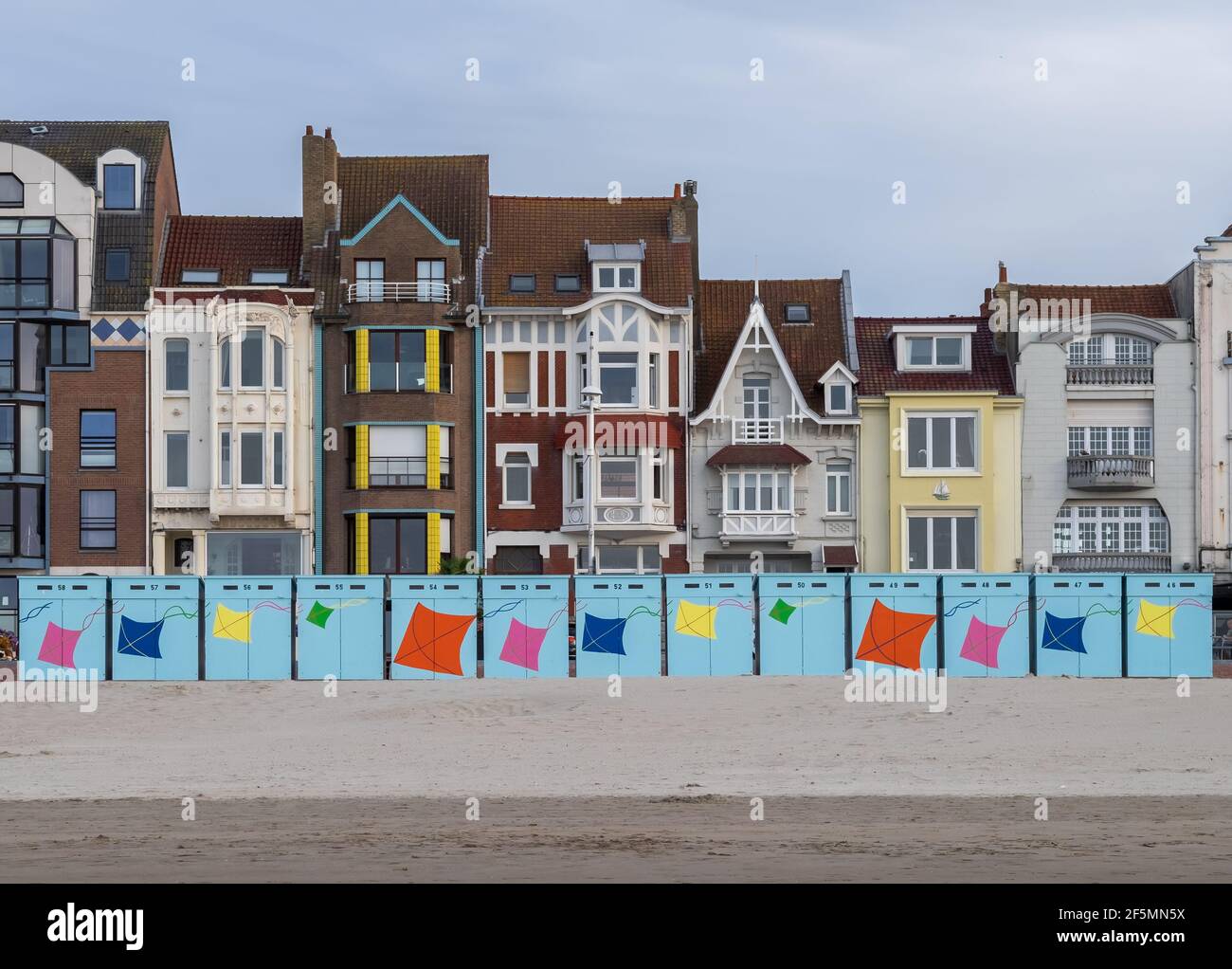 Dunkirk, France - 26 July 2020: Colorful beach huts in front of historic seaside buildings Stock Photo