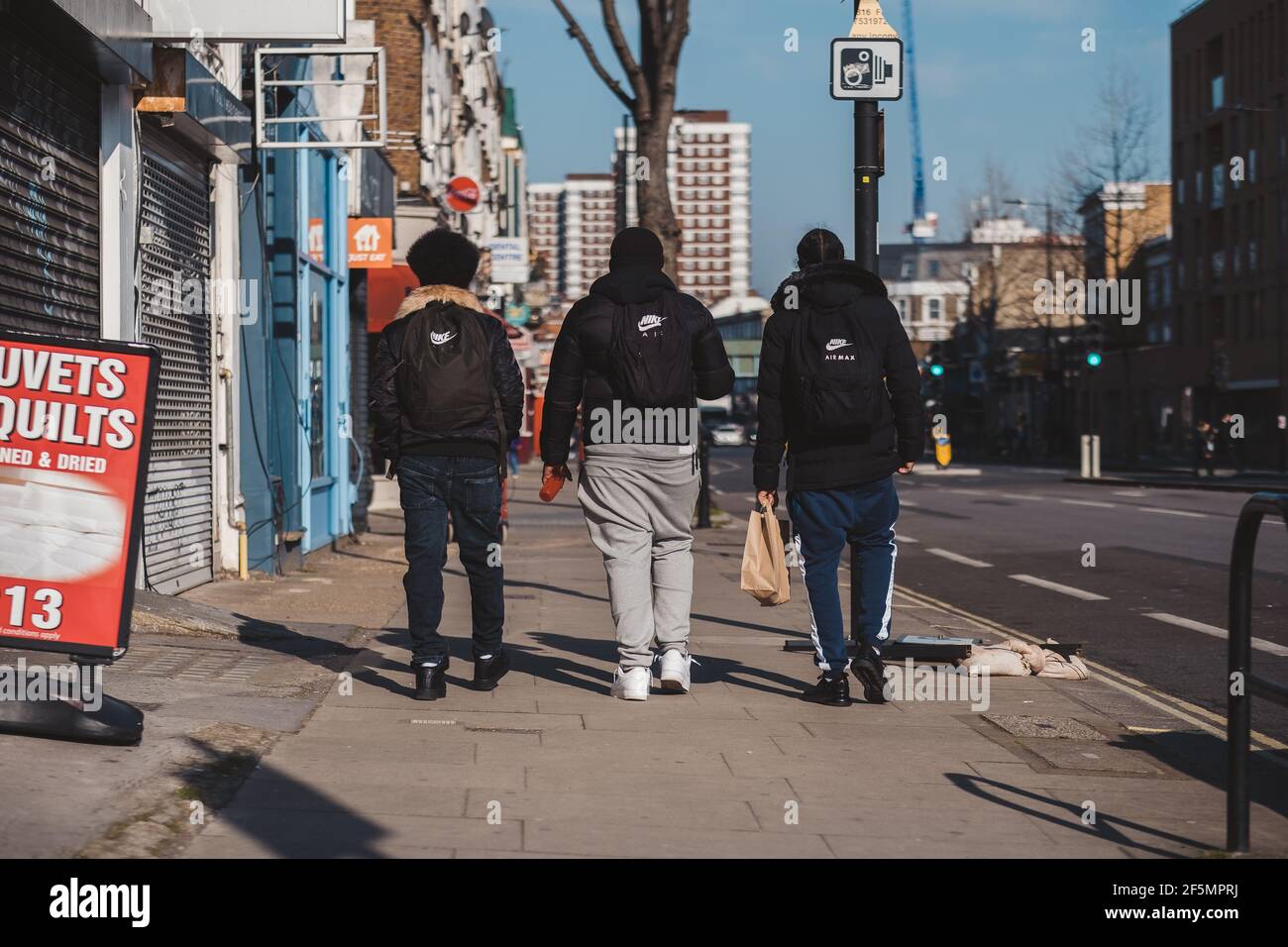 Shepherd's Bush, London | UK -  2021.03.22: Three young men walking down the street in the Urban dangerous dodgy area. Stock Photo