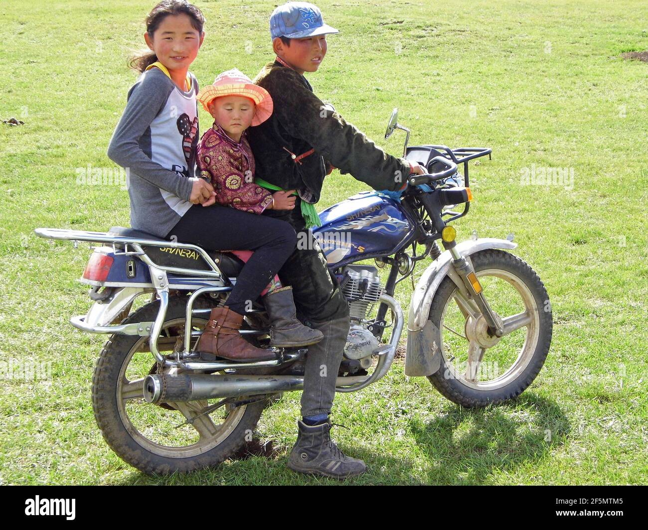 nomadic family on a motorbike, Mongolia Stock Photo