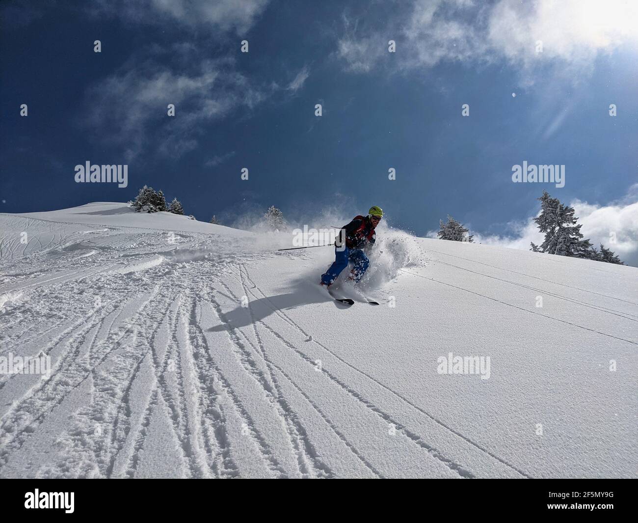 freerider skier drives through the powder snow down the mountain. Joy in life. Adventure in the swiss mountains. Glarus Stock Photo