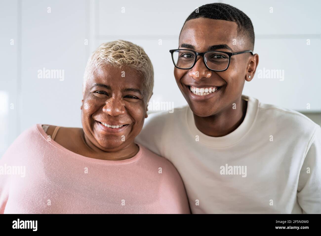 Happy smiling Hispanic mother and son portrait - Family love and unity concept Stock Photo