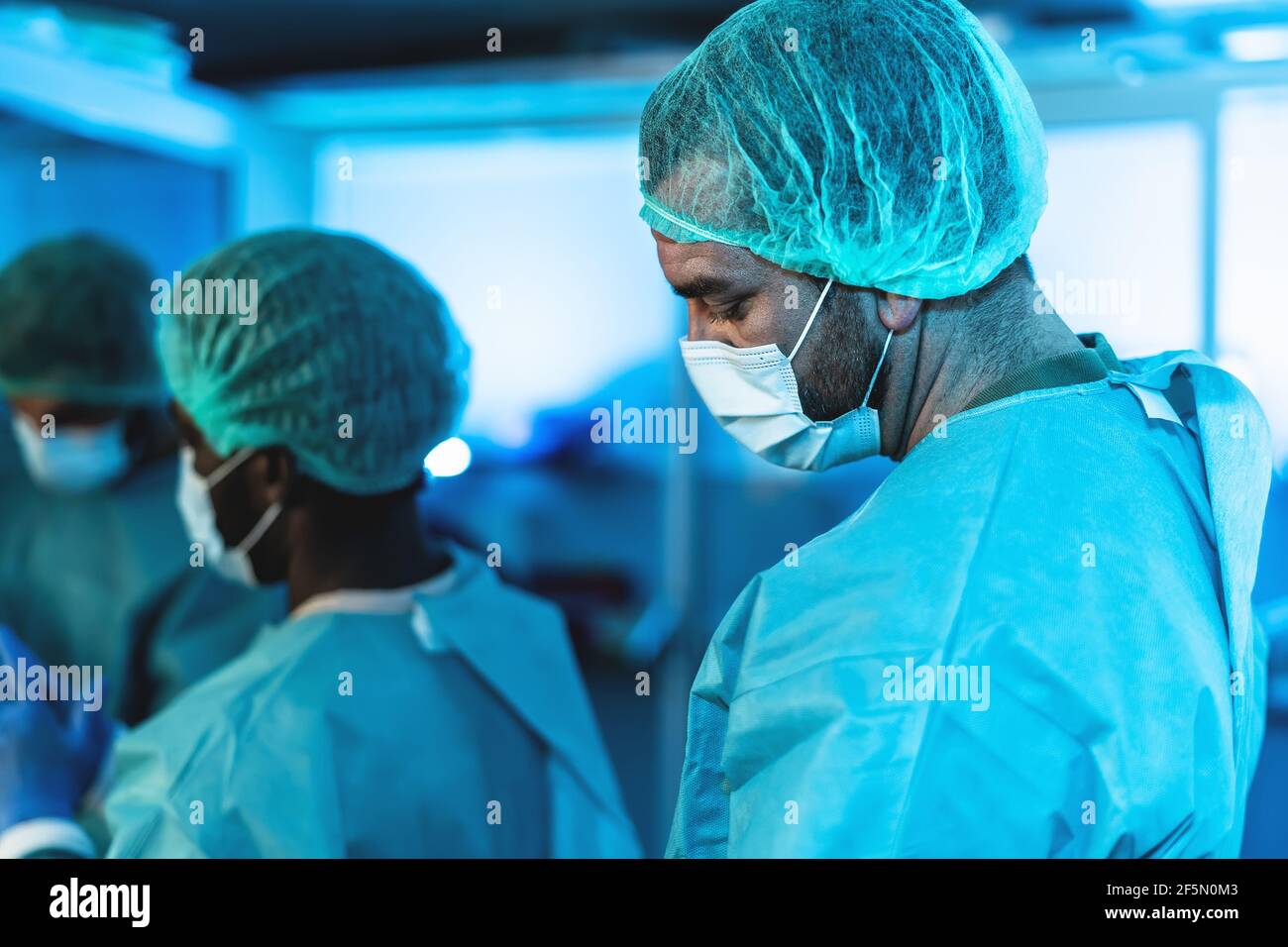 Doctors preparing inside surgical operation room - Medical workers getting ready for fighting against coronavirus pandemic Stock Photo
