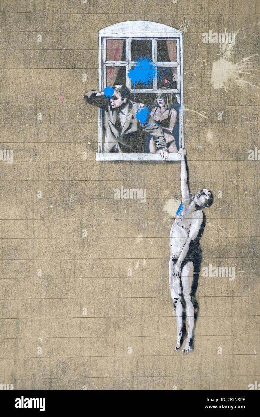 Banksy, spray paintin of naked adulterer hanging by window ledge from husband, 2006 Park Lane Bristol, England, UK Stock Photo