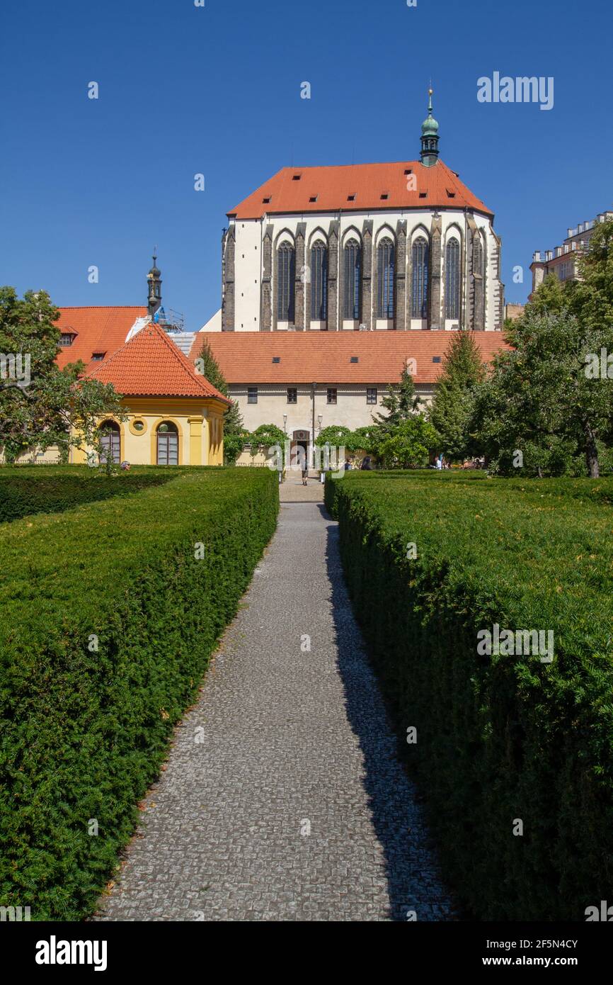 Franciscan Garden park in the centre of the city with hedge fences and gothic medieval Church of Our Lady of the Snows. Stock Photo