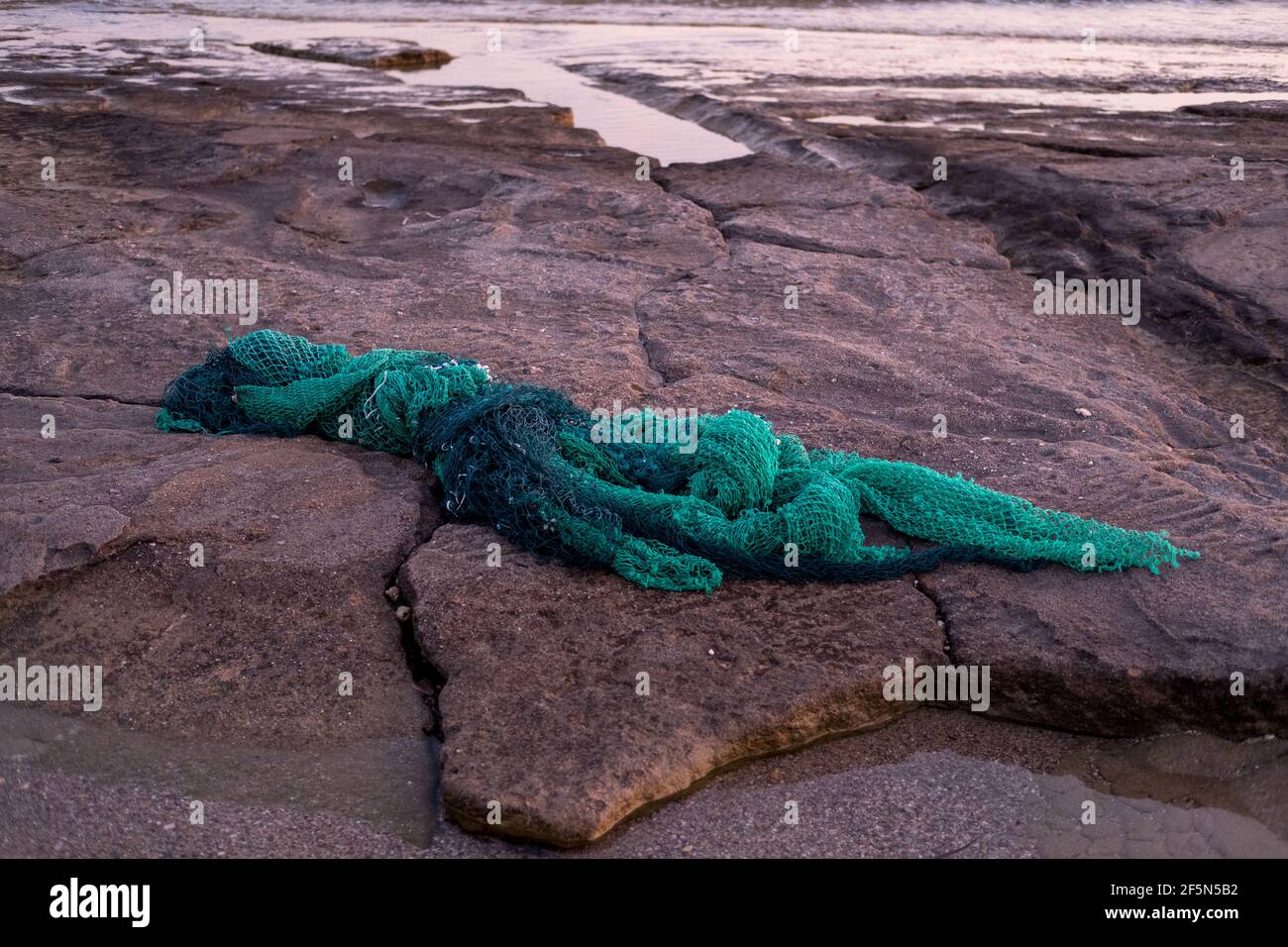 Sea pollution, discarded fishing net washed up on a Greek beach Stock Photo