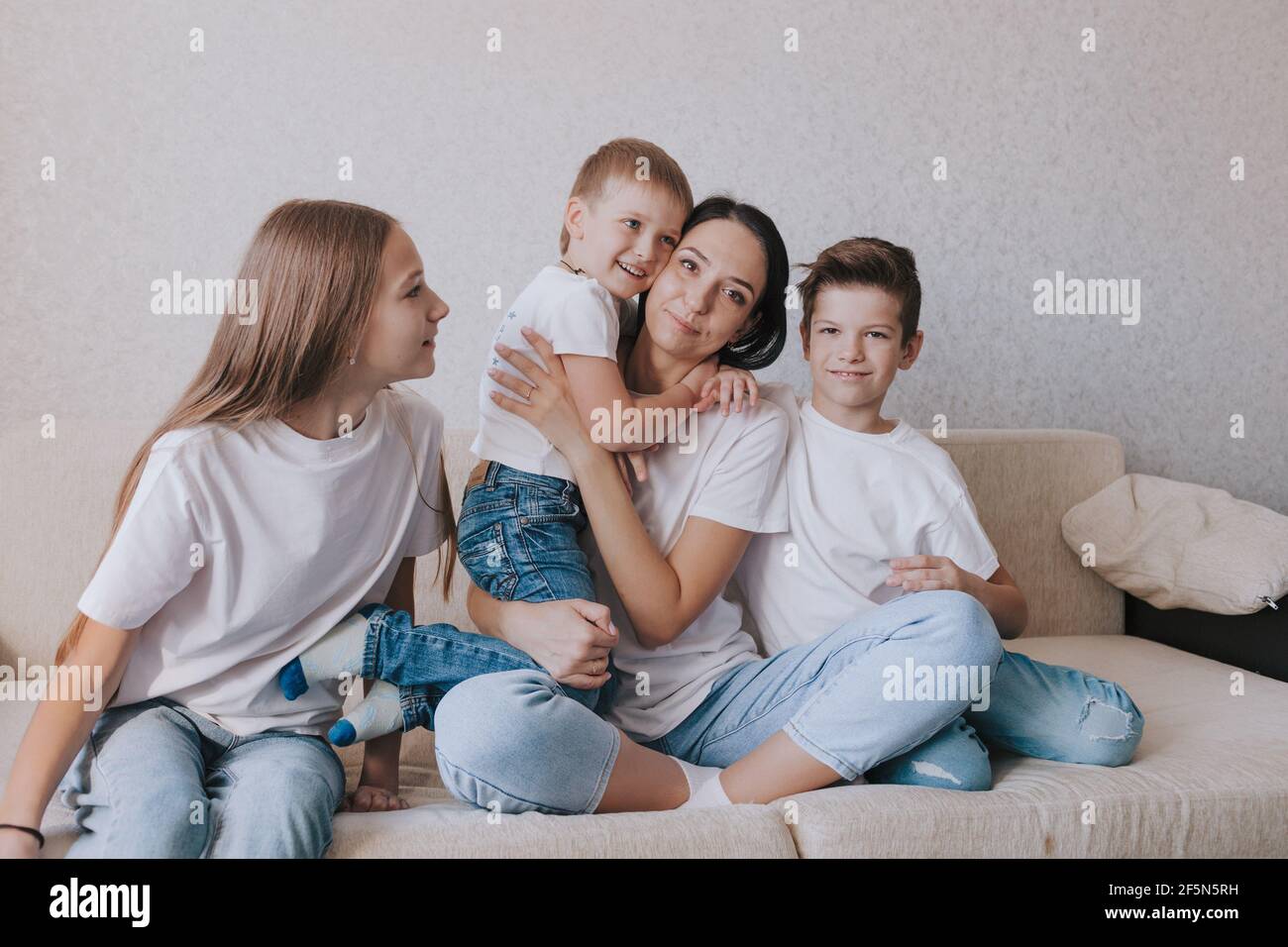 children in t-shirts and jeans isolated on white. Friends or brothers and  sisters Stock Photo - Alamy
