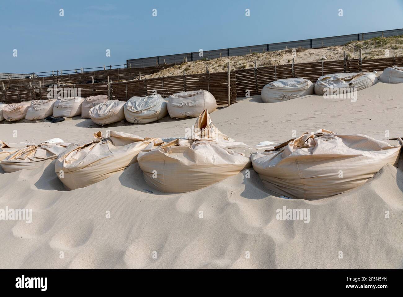 Sandbags used to stabilise coast at Shiokaze Cobalt Blue beach, Tsunoshima island, Japan Stock Photo